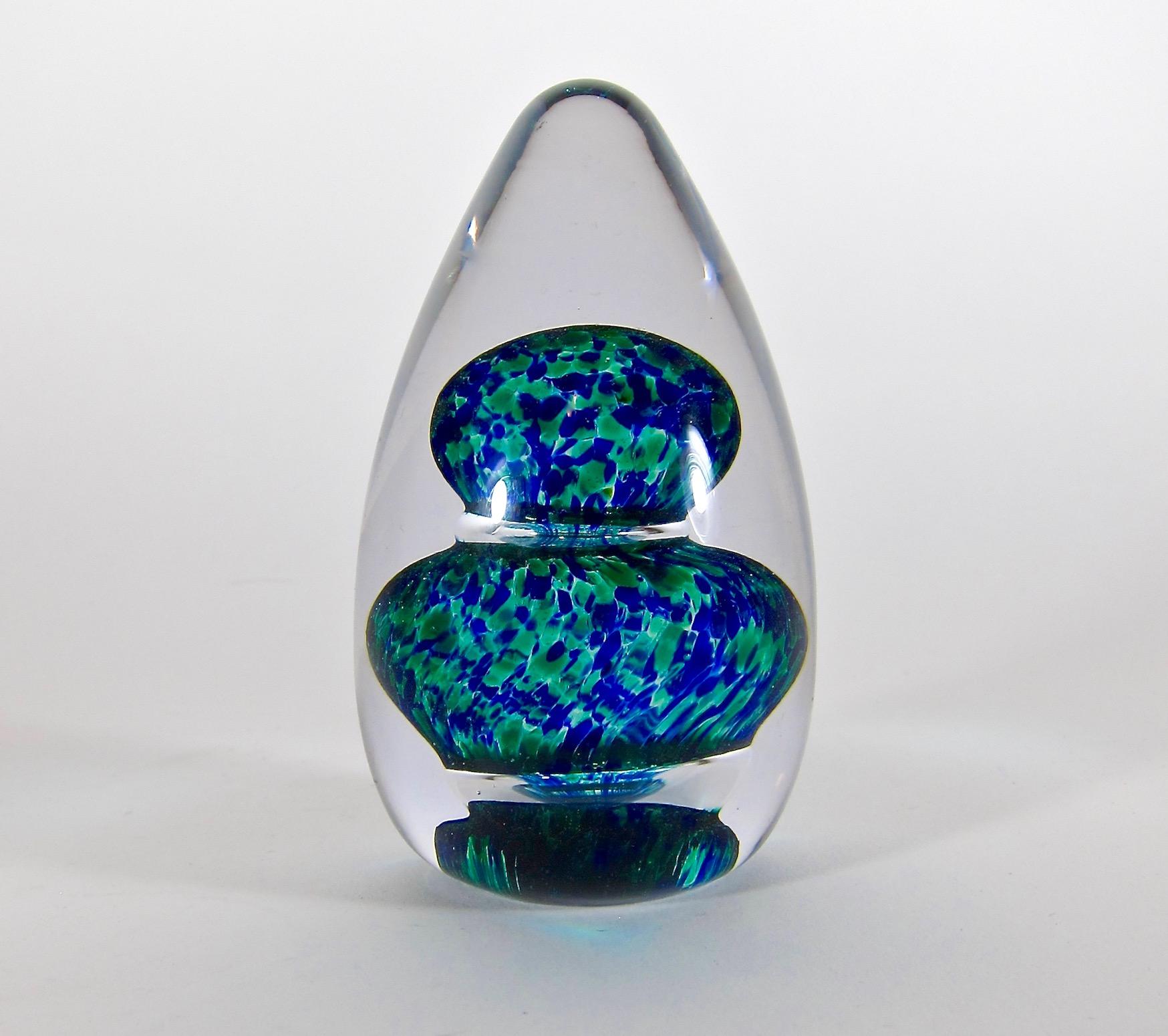 A vintage English paperweight handcrafted at Wedgwood Glass from clear, green and dark cobalt blue glass, circa 1974. The colorful egg or dome shaped, art glass weight was designed by Ronald Sennett-Willson in the late 1960s. Stennett-Willson was