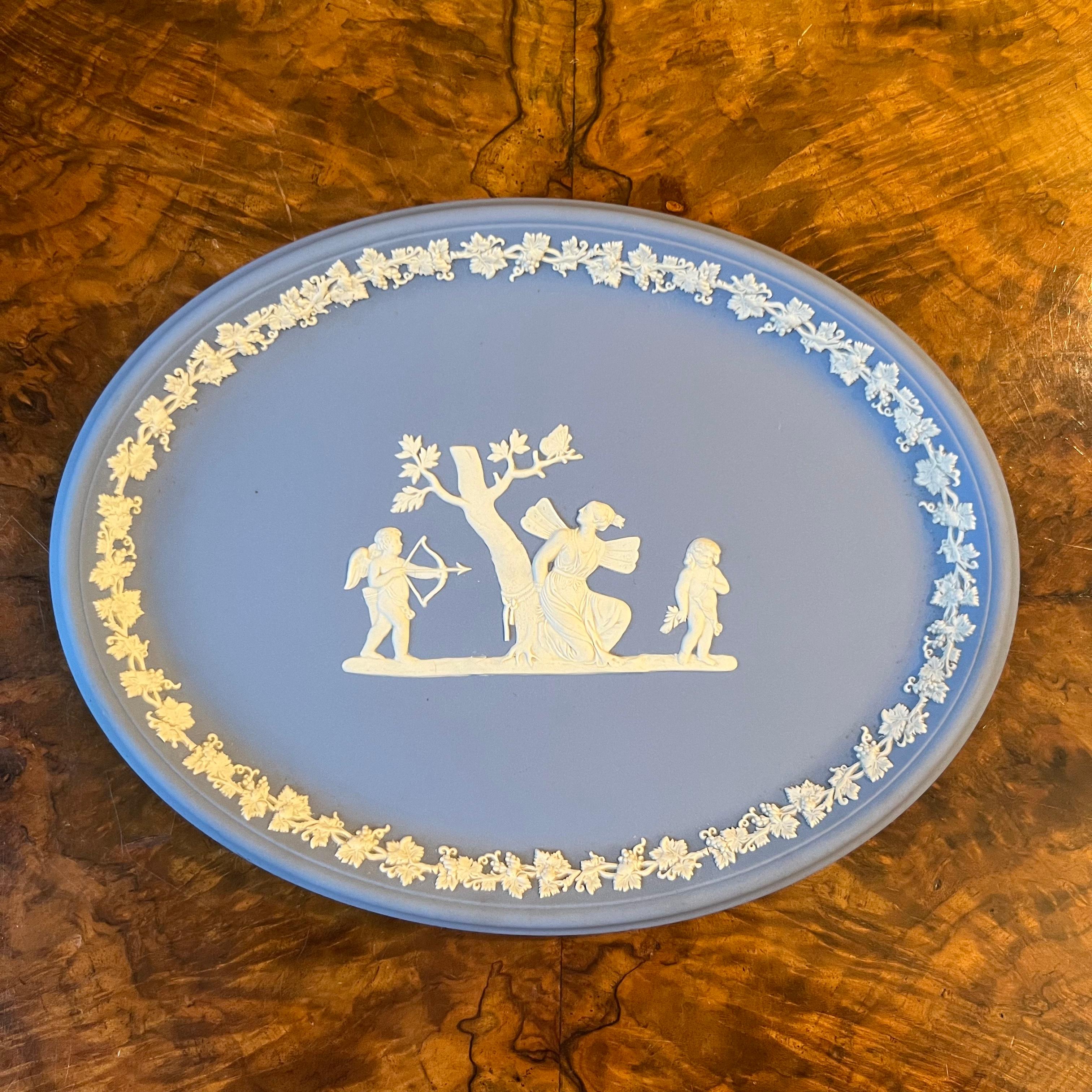 Blue and print design cherubs and lady, there are some marks on the back of plate see photo, stamped Wedgwood

Circa: 1950s

Material: Porcelain

Country Of Origin: England 

Measurements: 1.5cm high, 25cm length, 18cm width 