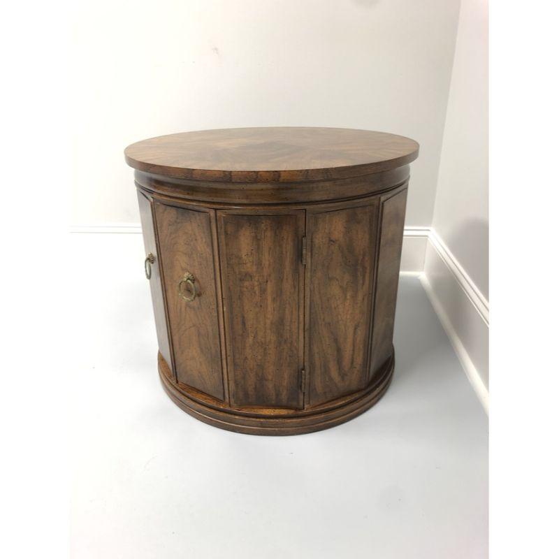 A round side or accent table in Walnut by Weiman. Made in the USA in the mid 20th Century. Banded top. Cabinet behind double doors.

Measures: 25 W 25 D 22 H

Very good vintage condition. Signs of light use. Structurally sound and sturdy. Condition