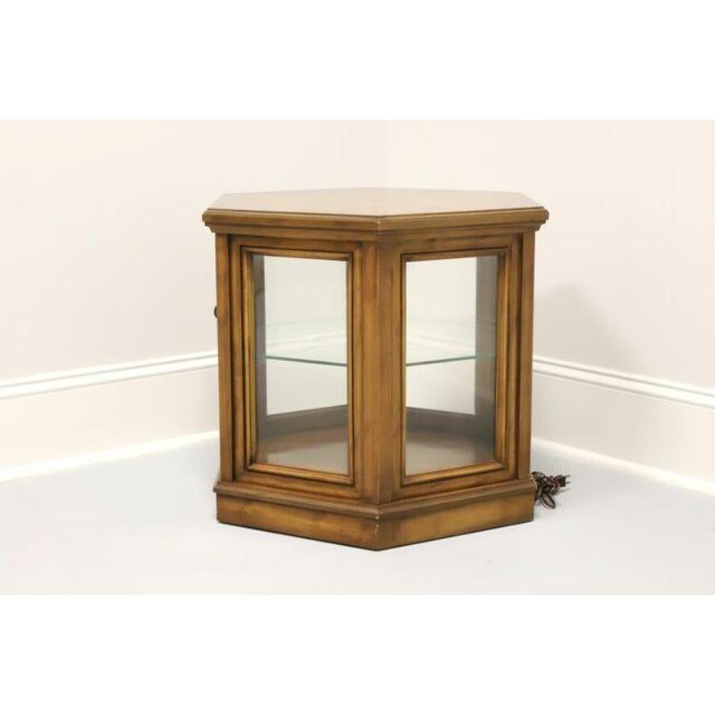 A mid century hexagonal shaped accent cabinet by Weiman. Made of walnut with six glass sides, one being a door with a brass pull. Made in the USA in the Mid 20th Century. Features lighted interior display area with one fixed glass shelf.

Measures: