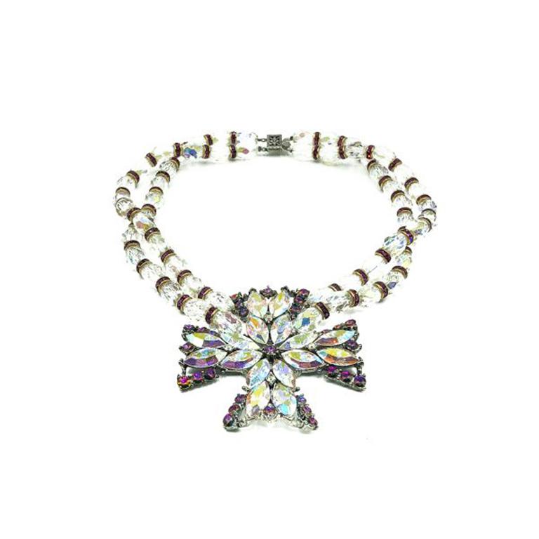 A Vintage Weiss Maltese Cross Collar from the 1950s. Featuring a double strand necklace with a statement maltese cross style centrepiece. Crafted with irredescent aurora borealis crystal stones and glass beads in combination with shocking pink