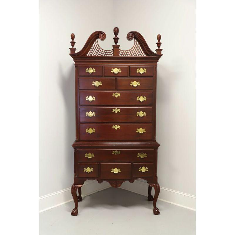 A Chippendale style highboy chest on chest by Wellington Hall. Solid Mahogany with brass hardware. Features twelve dovetail drawers of various sizes, four of the drawers have faux lockplates. Complimented by a pediment top with center & side