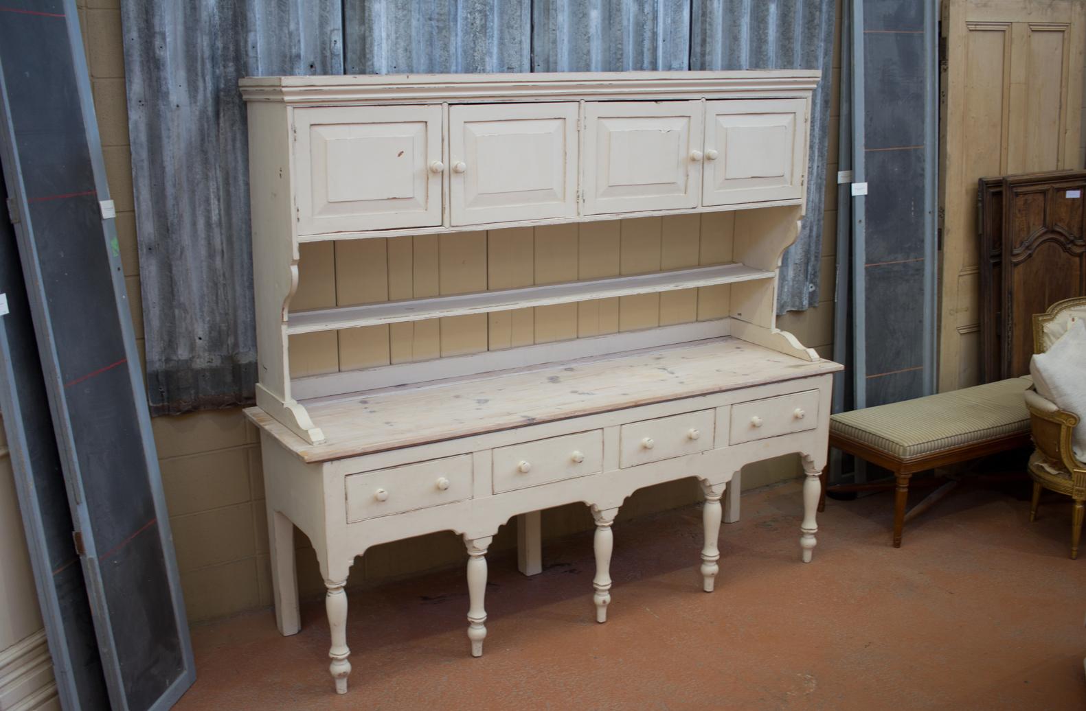 Vintage early 20th century Welsh painted dresser/kitchen cupboard. Dresser base sits on five turned legs with four drawers. The dresser top is slat back with a pot shelf and two double doors above. Great size and very quaint.