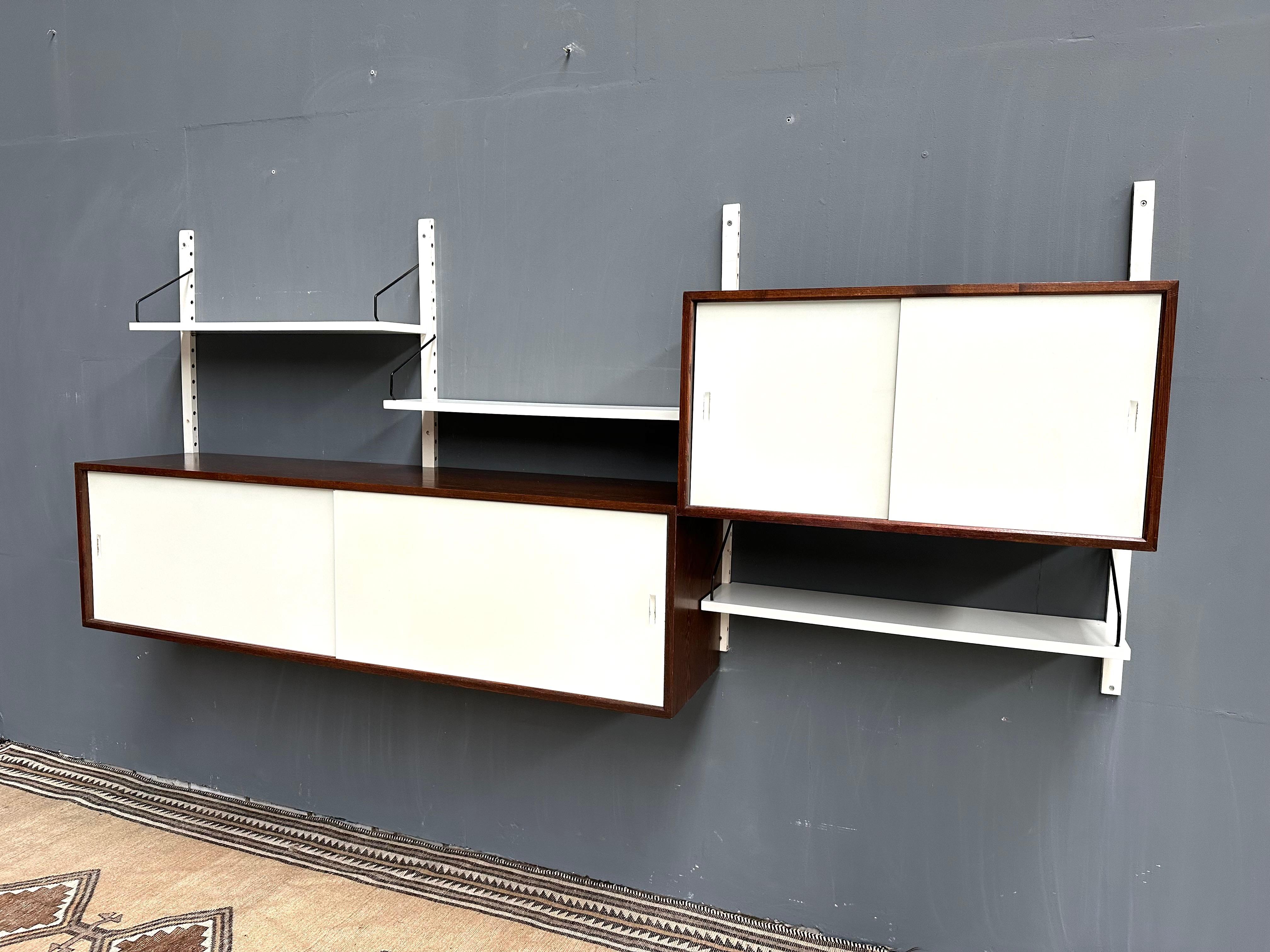 Modular Royal System wall unit  in wenge and white. Designed by Poul Cadovius in the Sixties. Manufactured by CADO in Denmark. The individual elements of the wall system are made of wenge veneer and white lacquered shelves and doors. The uprights