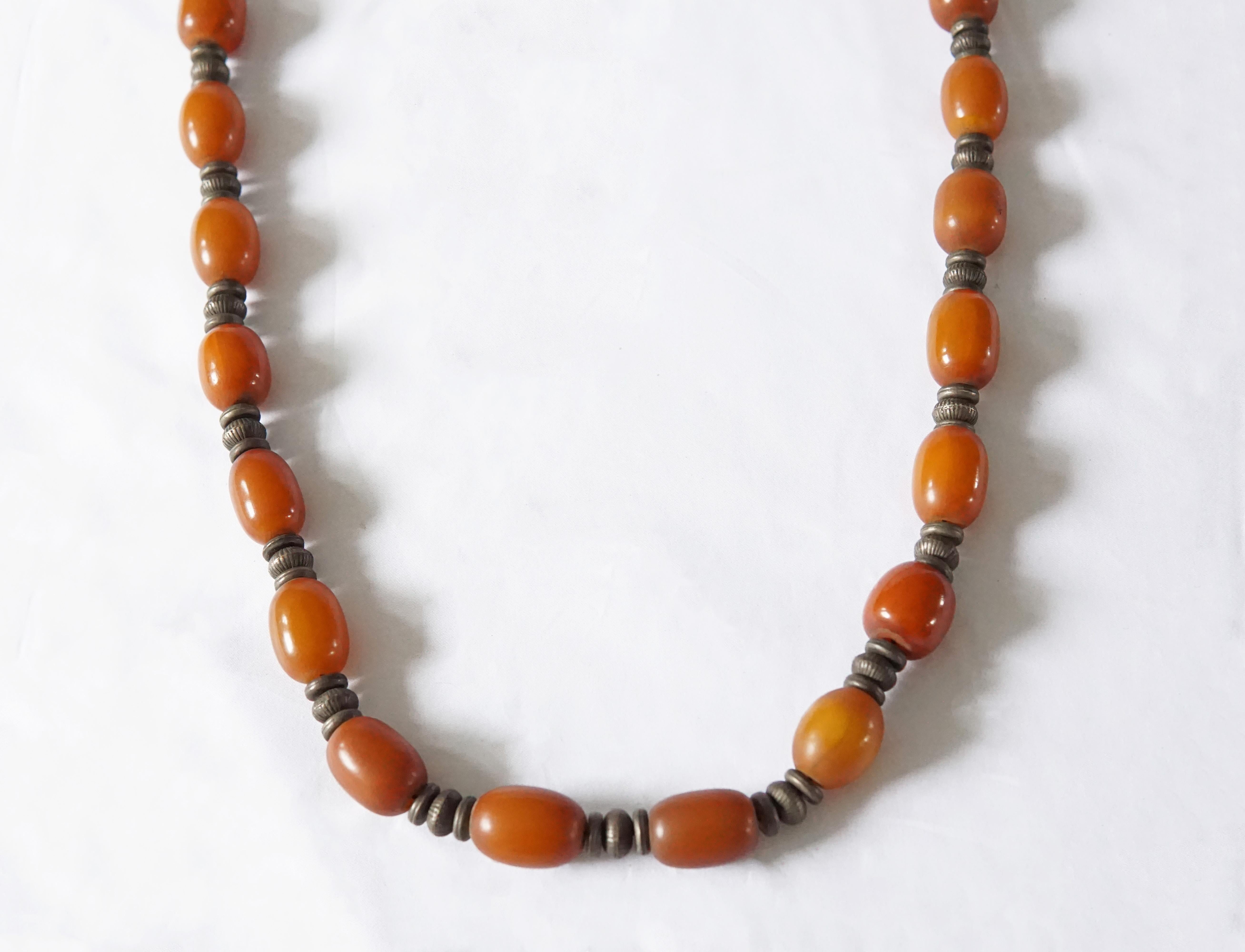 A long vintage necklace hand-crafted from West African orange Copal Amber beads with Silver spacers.

Dimensions: drop length 47 cm x depth 1.5 cm width 3 cm
Weight; 90 grams
Bead size: length 2 cm x depth 1.5 cm.

