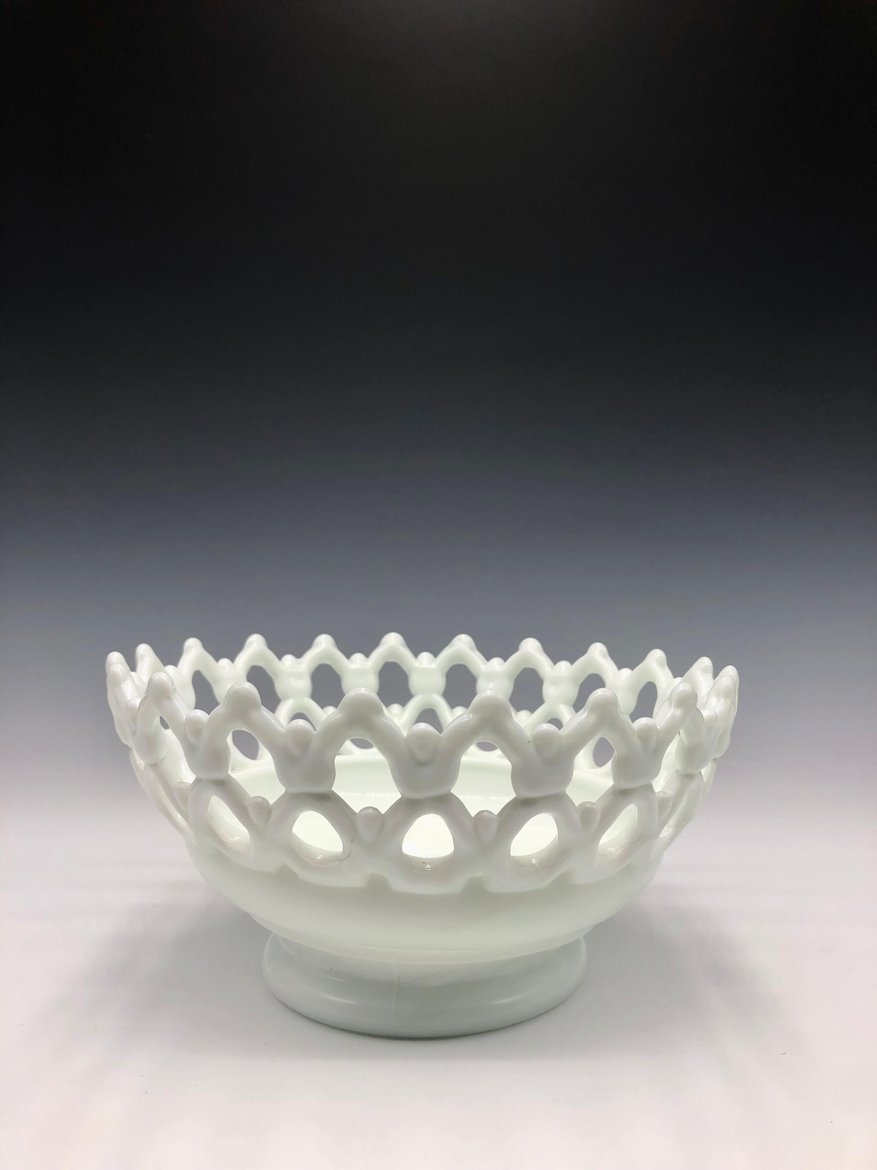 Westmoreland Glass Company (Pennsylvania, USA) Doric Milk Glass Bowl.

Whimsical white vintage Westmoreland milk glass bowl with figure-shaped lattice detail.  

Size: 4