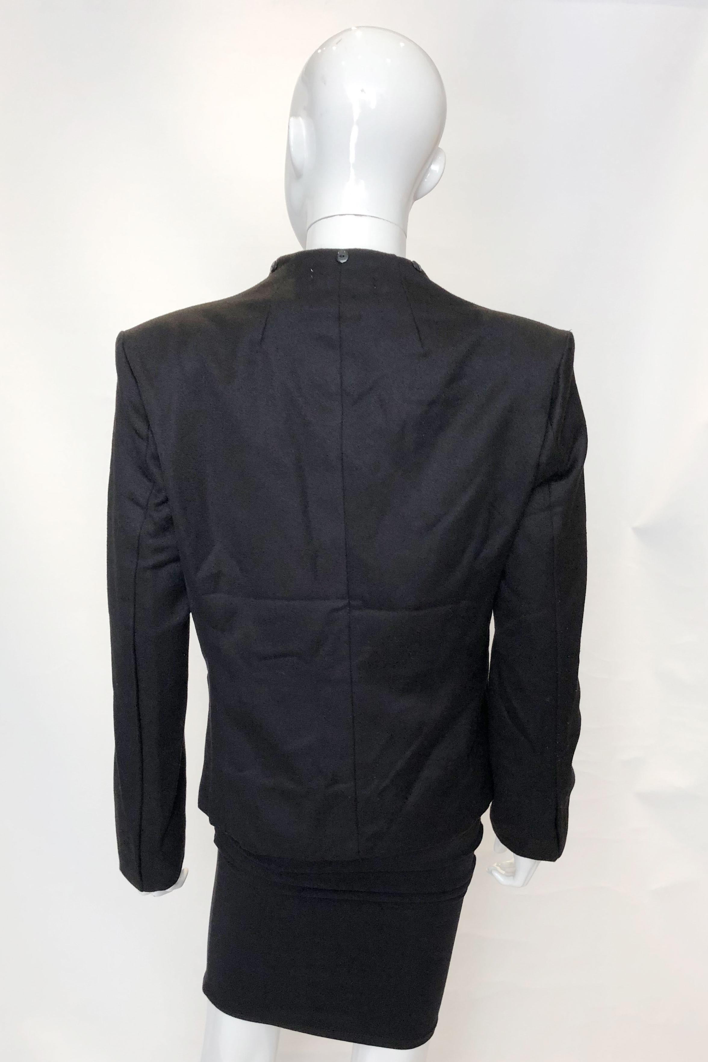 A chic jacket by Westwood London. This wool jacket is fully lined and has a cut away collar with buttons for fastening a collar /scarf. Alternatively they can easily be removed. 
