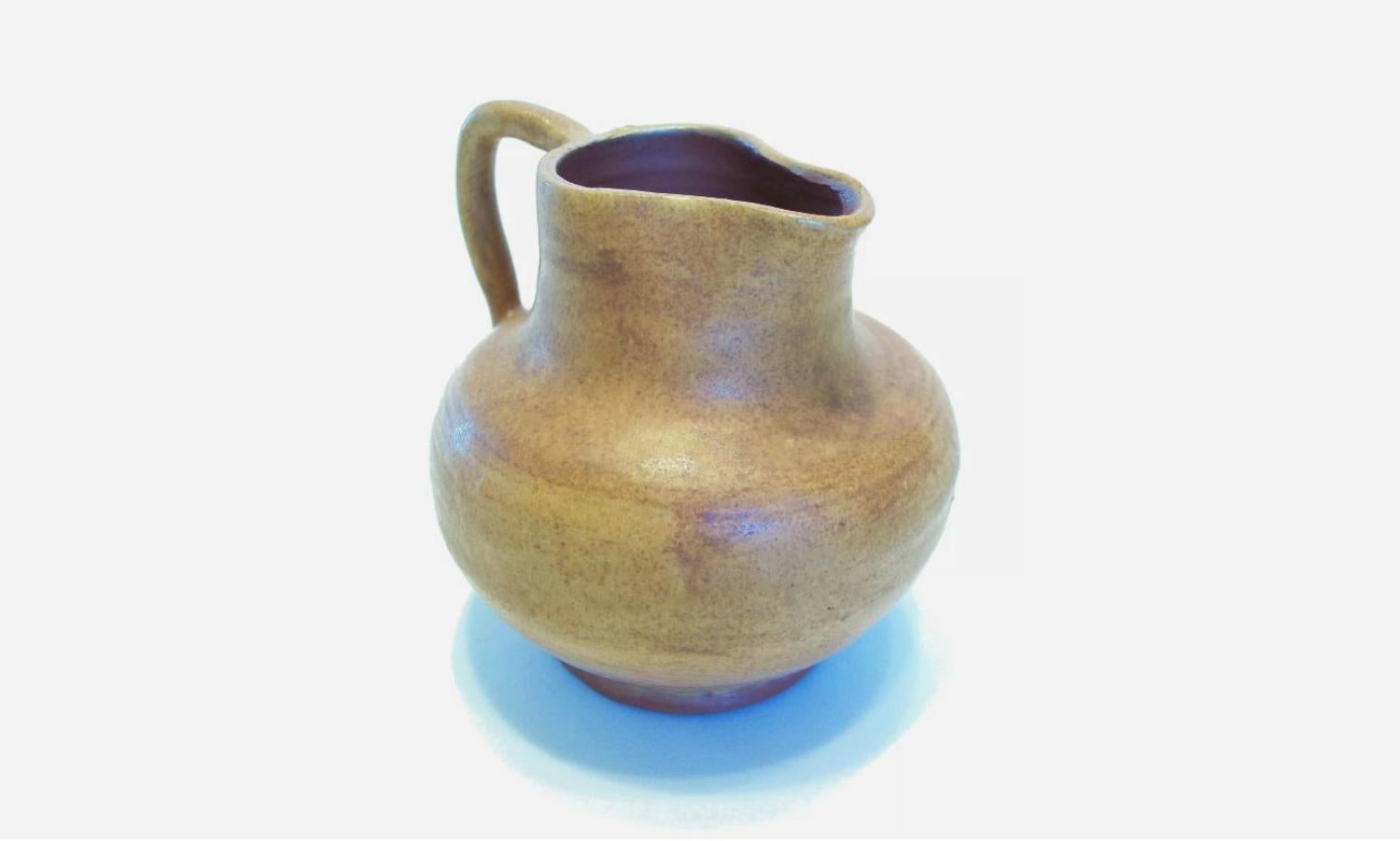 Vintage wheel thrown glazed terracotta miniature jug - extremely fine/thin body/turning - hand modeled handle - unsigned - mid 20th Century.

Fair vintage condition - one firing crack at the base rim that goes through to the interior (not affecting