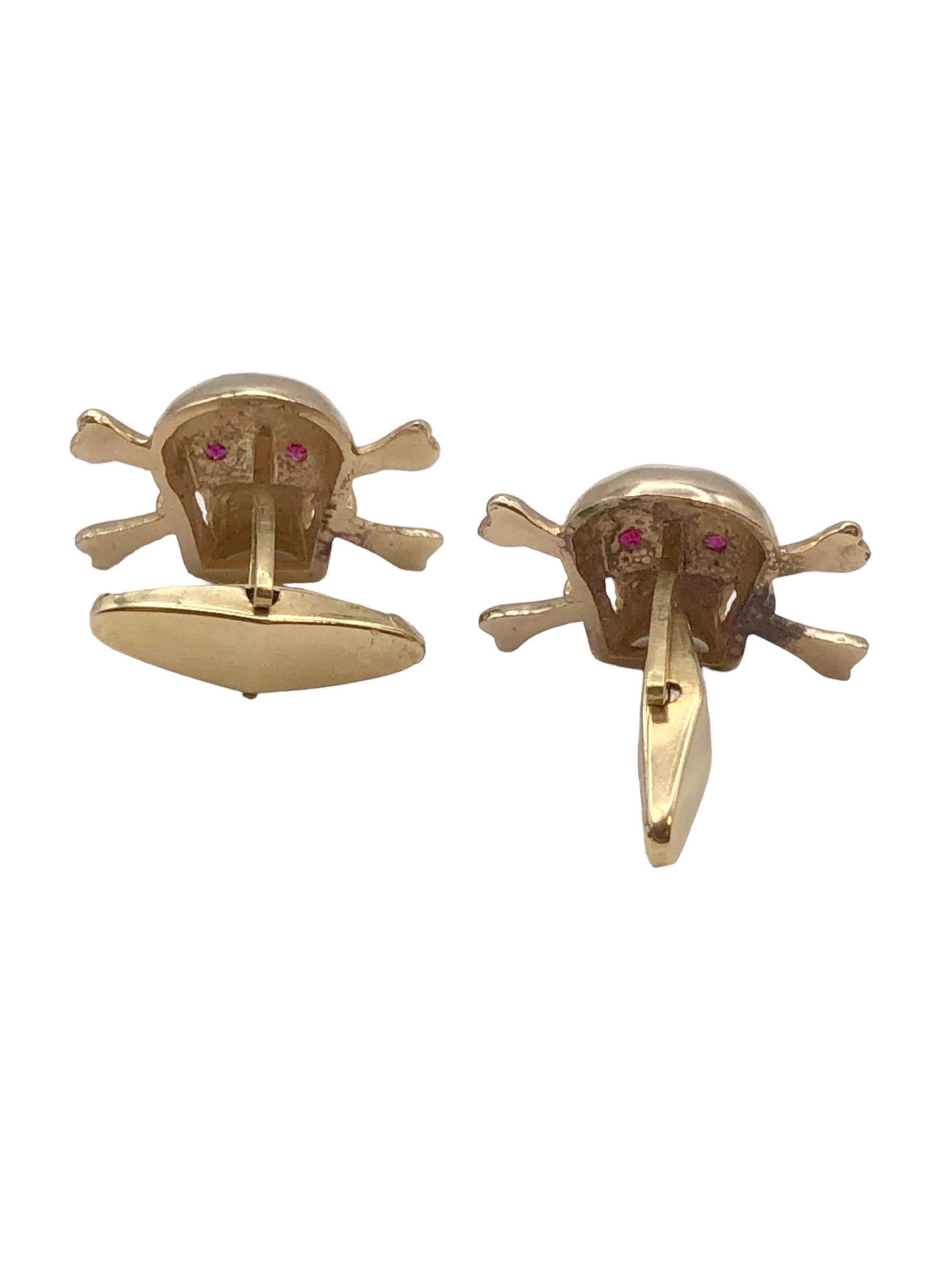Circa 1970s 18k Yellow Gold Skull and Crossed Bones Cufflinks, measuring 5/8 x 5/8 inch, nicely detailed with Ruby set Eyes. Toggle backs for easy on and off. 