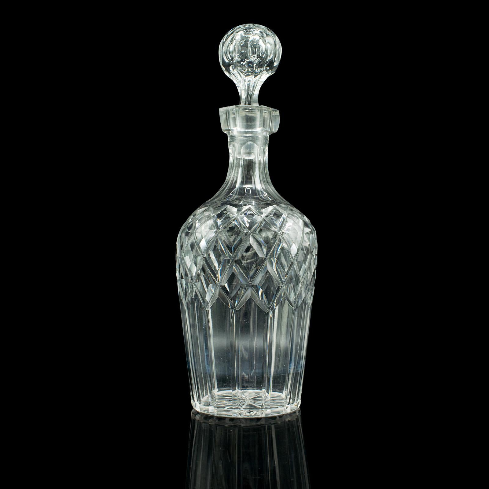 This is a vintage whiskey decanter. An English, cut glass decorative Scotch vessel, dating to the mid 20th century, circa 1960.

Nicely presented decanter with distinctive cut appearance
Displays a desirable aged patina and in good order
Cut