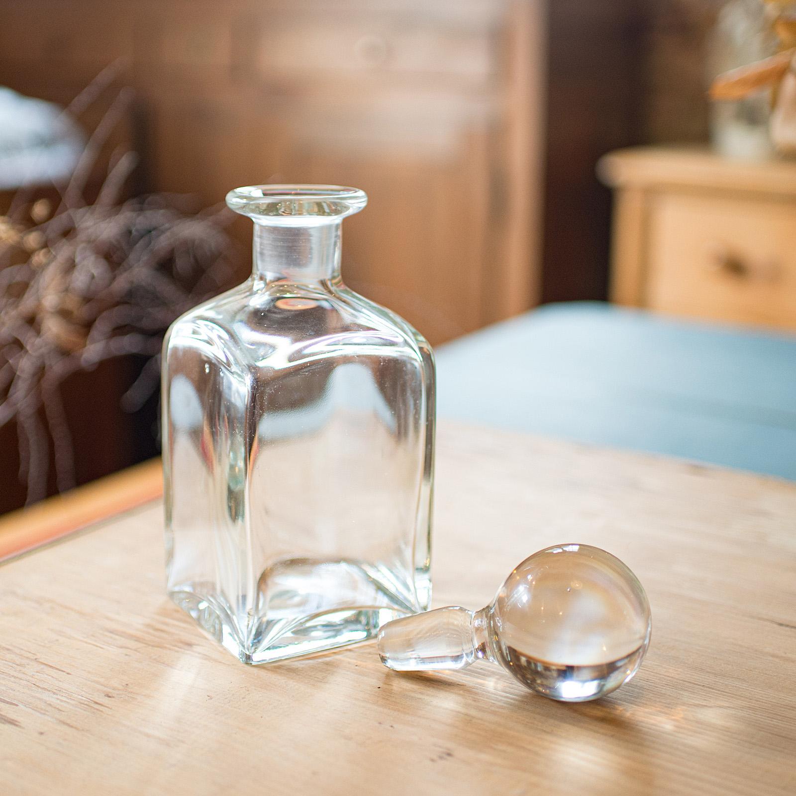 
This is a vintage whisky decanter. An English, glass bourbon or spirit vessel, dating to the mid 20th century, circa 1960.

Appealingly broad glass to this substantial decanter - ideal for the home bar
Displays a desirable aged patina and in good