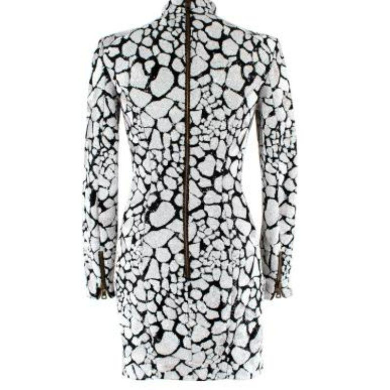 Balmain Vintage White and Black Sequin Mini Dress
 
 
 
 - All over black and white sequin patch design
 
 - High neck
 
 - Slim fitting 
 
 - Patch pockets
 
 - Chunky zip sleeve detail 
 
 - Back zip fastening 
 
 - Fully lined with black silk 
 
