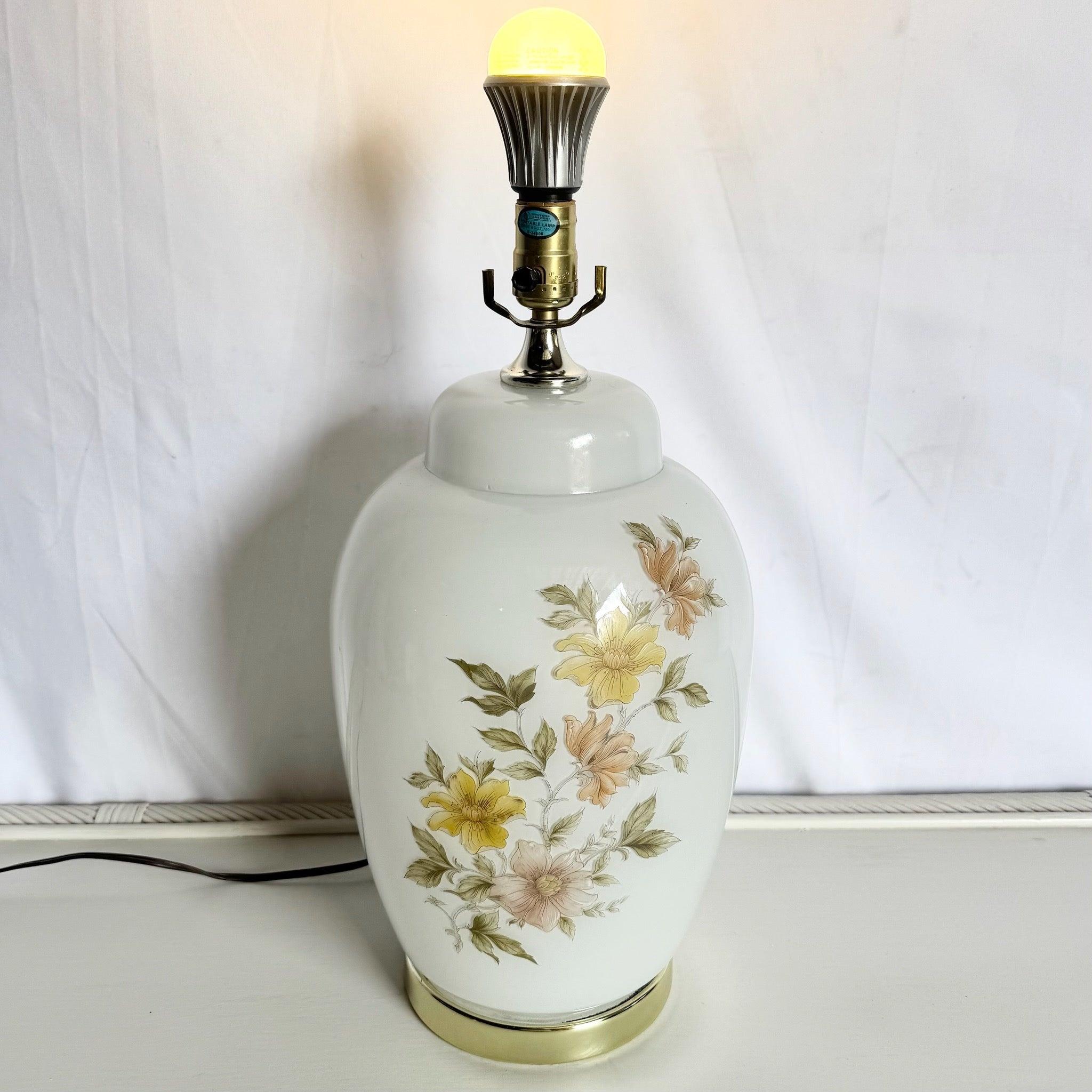 Vintage White Glass Lamp With Floral Touch—frosted glass, hand-painted pastel blooms, and gold base—perfect for elegant coastal or vintage-style interiors.
 

 We sell items as acquired, without restoring or repairing. Vintage pieces may have