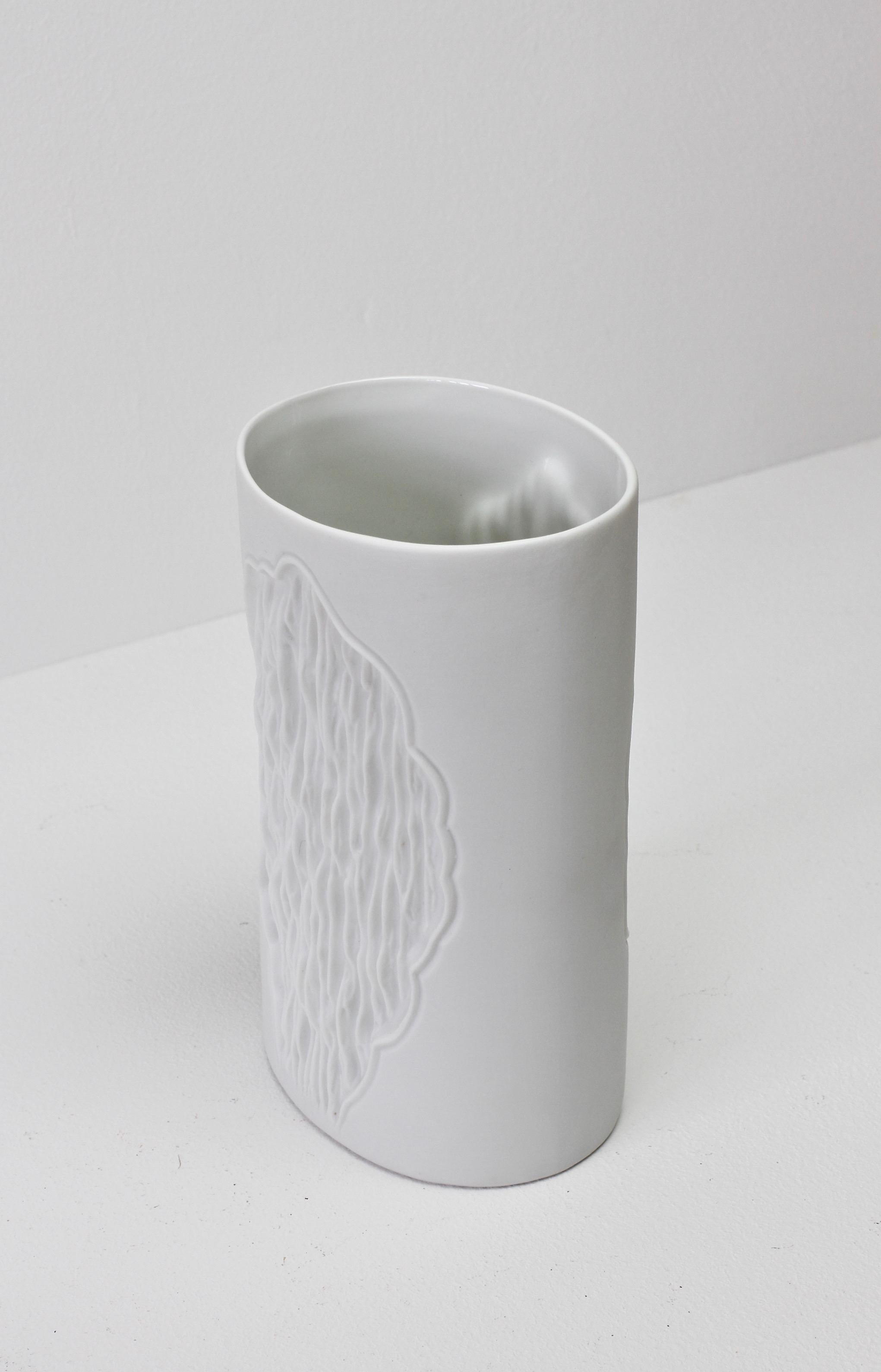 A vintage white bisque vase featuring an organic textured 'exposed rock' relief pattern designed by Manfred Frey for AK Kaiser Porcelain, circa 1980s.

Model/shape number 0648.
