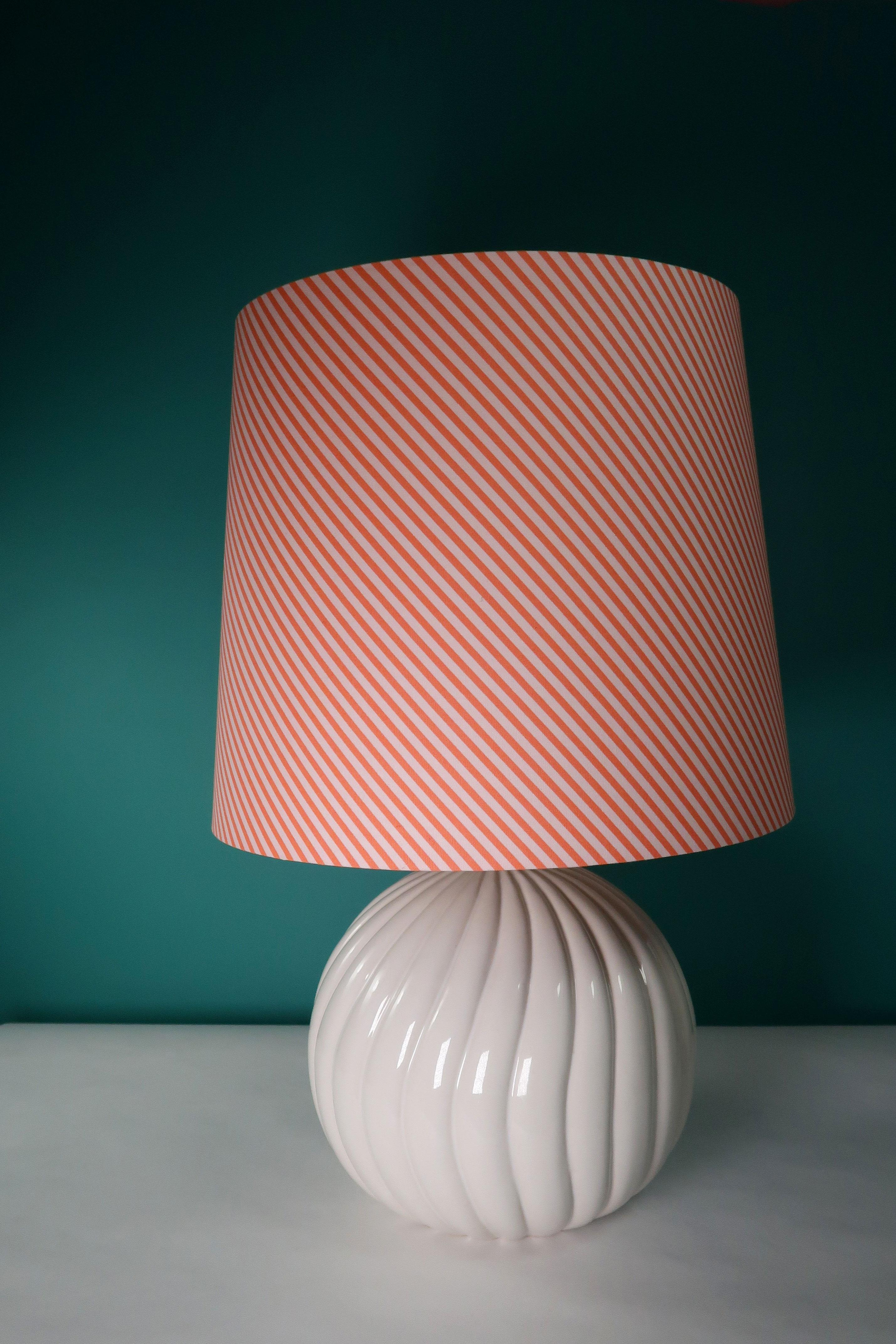 Warm white Mid-Century Modern ceramic table lamp in the style of Tommaso Barbi. Swirling relief with crackling glaze and embellished brass top. Rewired with transparent cord. Original fitting with a slight slant. Excellent vintage condition. 
Italy,