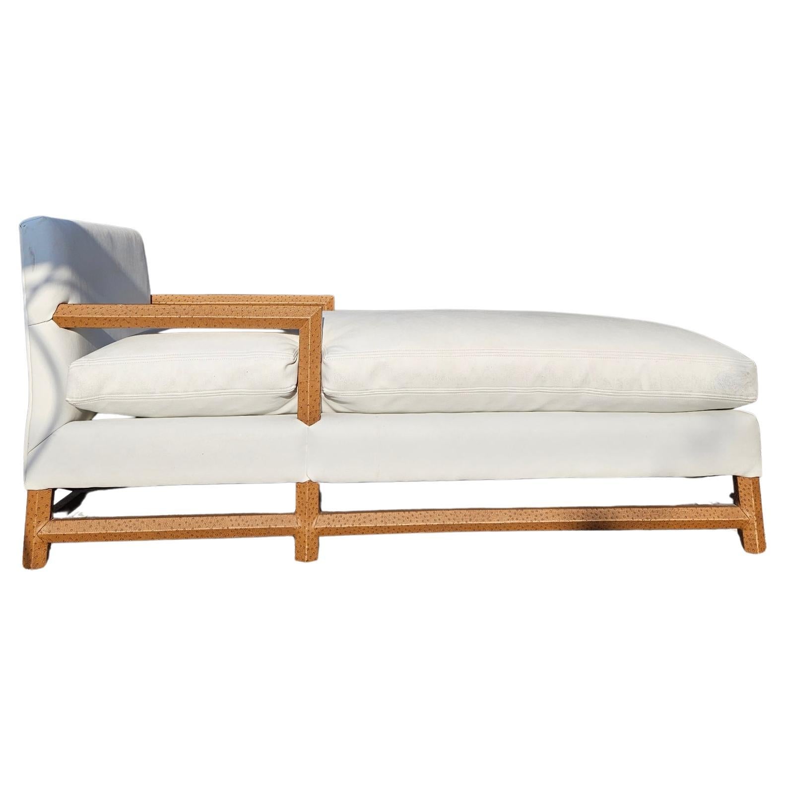 Vintage White Chaise Lounge with Faux Ostrich Leather Accents
 Vintage chaise lounge in white upholstery with faux ostrich leather-wrapped arms, feet, and stretchers. This elegant piece features minor age-appropriate wear, enhancing its character.
