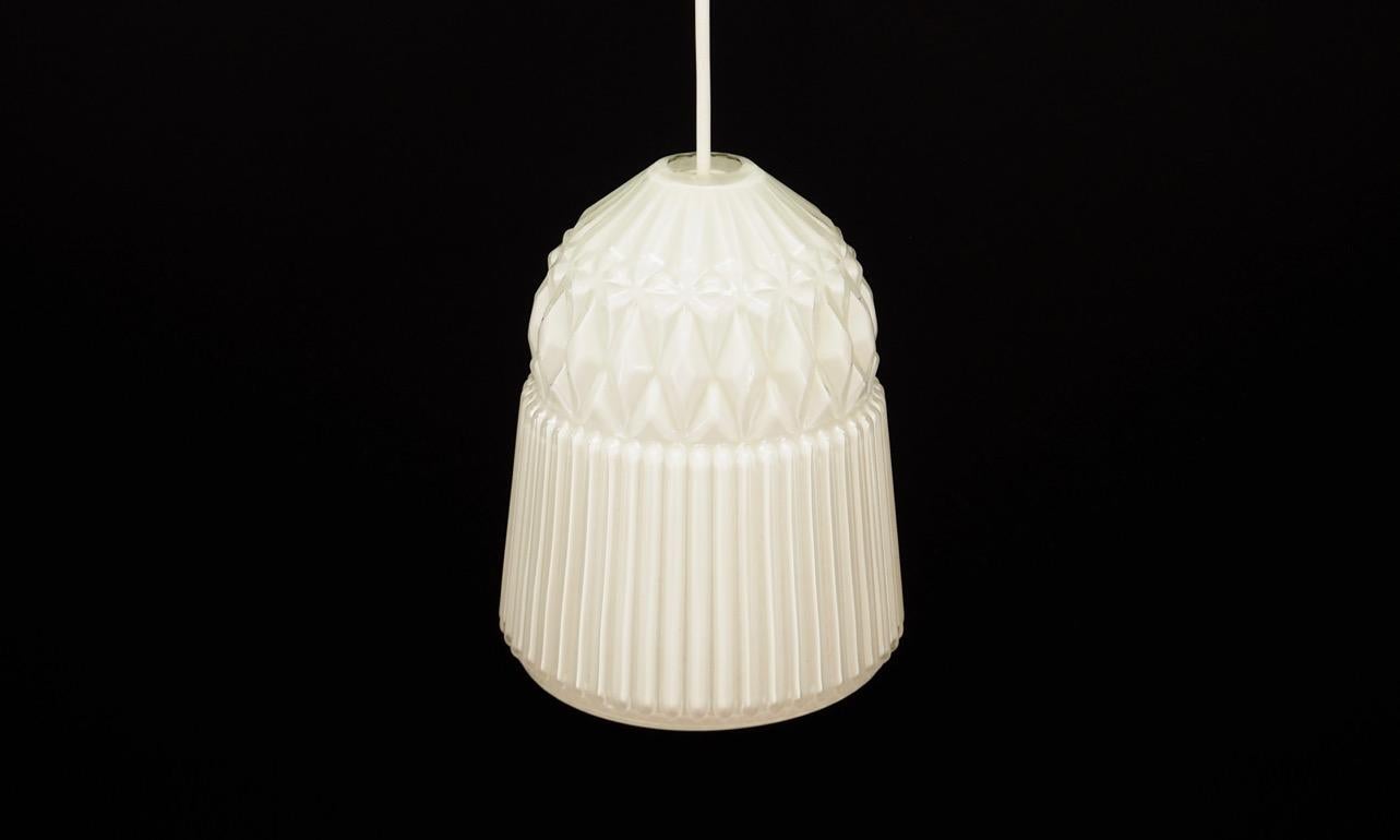 Wonderful chandelier from the 1960s-1970s, Scandinavian design. Lamp is made of white glass. Maintained in good condition (minor abrasions), directly for use.

Dimensions: Height 21 cm, diameter 17 cm.