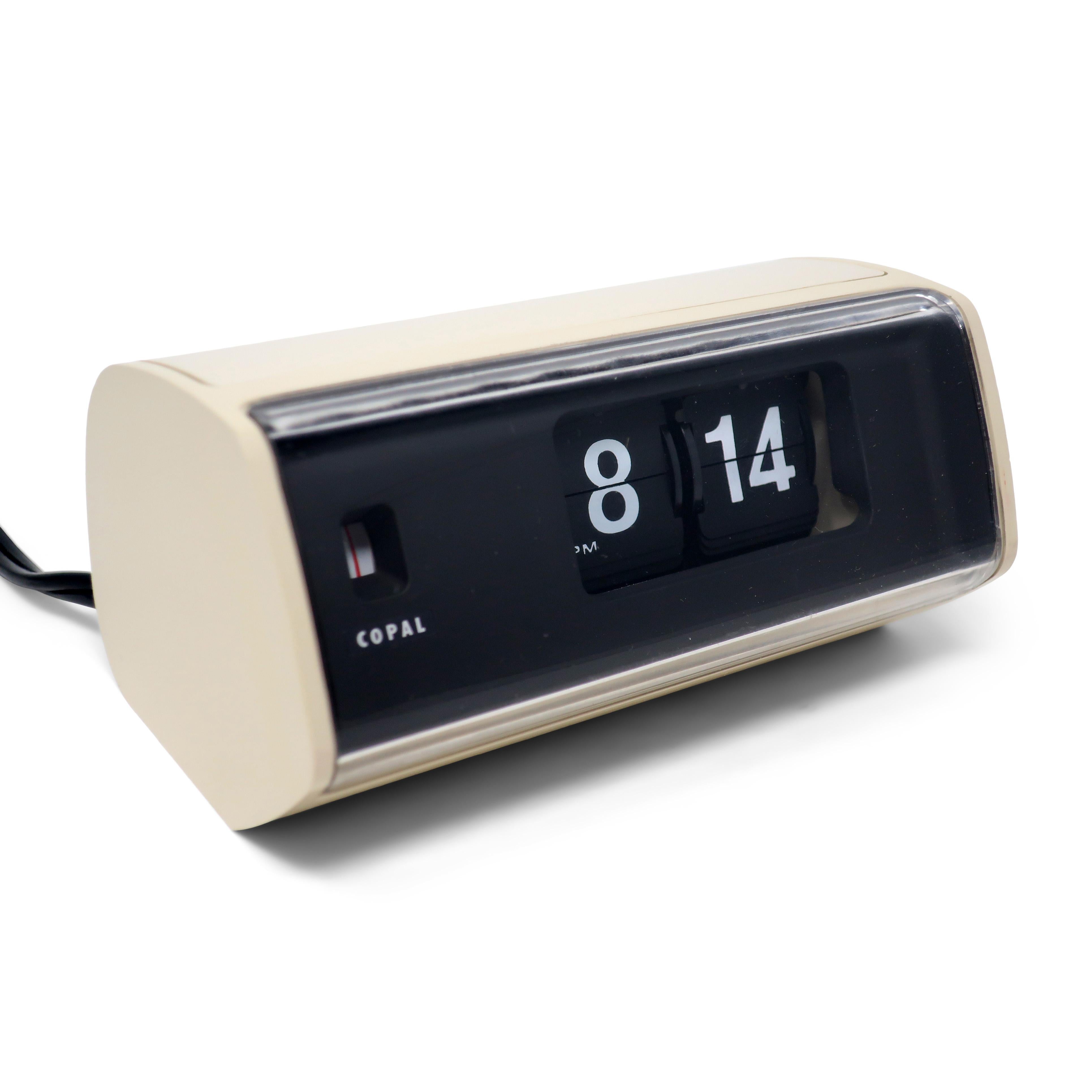 A beautiful Mid-Century Modern Copal Model 222 flip clock with white plastic case, black face, and clear plastic front. Minutes and hours flip as time passes, providing a satisfying quiet sound. Looks fantastic and works great!

In very good