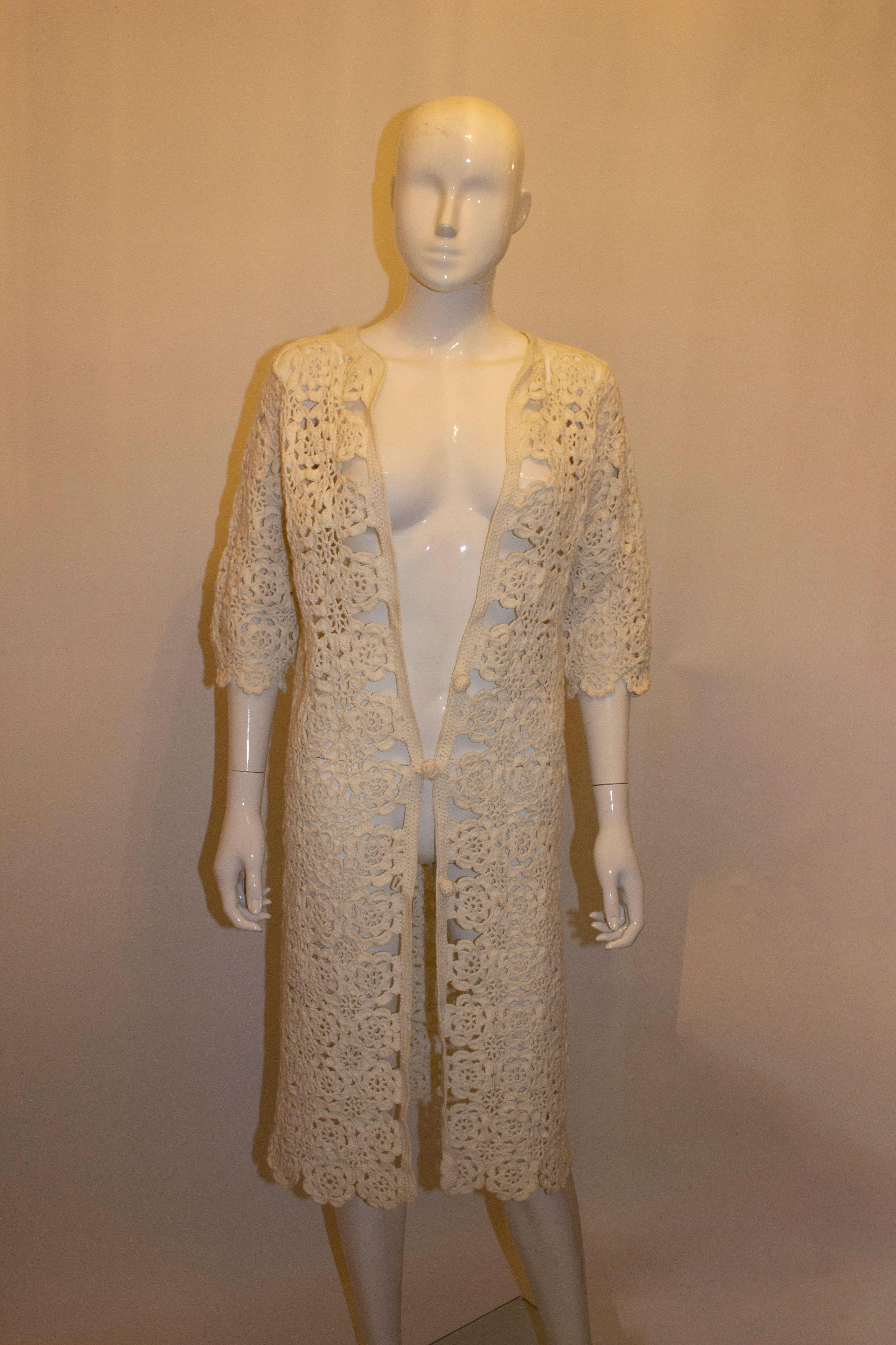 A stunning vintage white crochet coat, ideal for the Summer season. 
It has elbow length sleaves and a three button front fastening.
Measurements: Bust up to 38'', length 43''