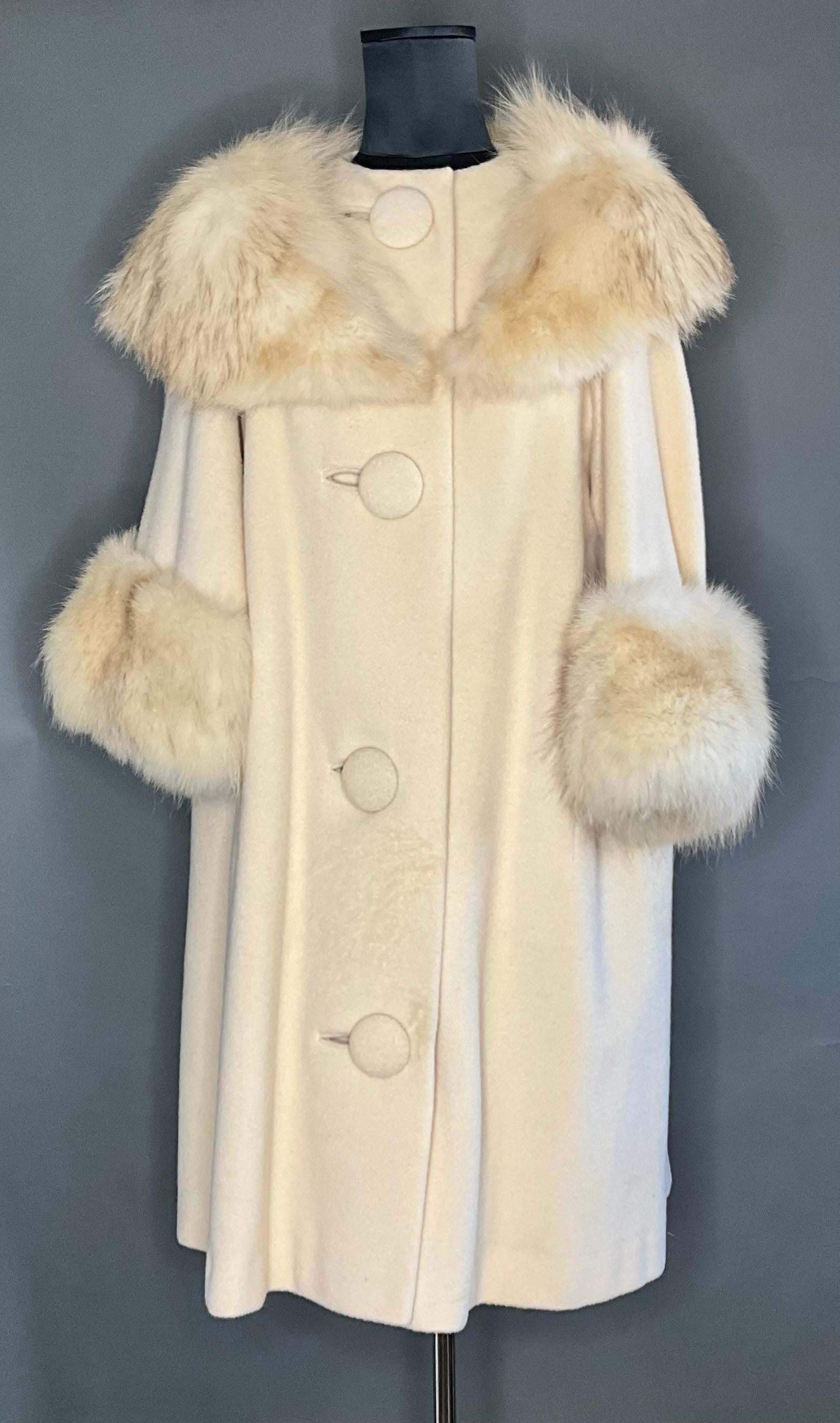 This Vintage White Cuddle Coat with Fur Detail is a cozy and luxurious outerwear piece that combines warmth with an elegant, vintage-inspired aesthetic. Known for their luxurious design and quality craftsmanship, cuddle coats offer comfort and