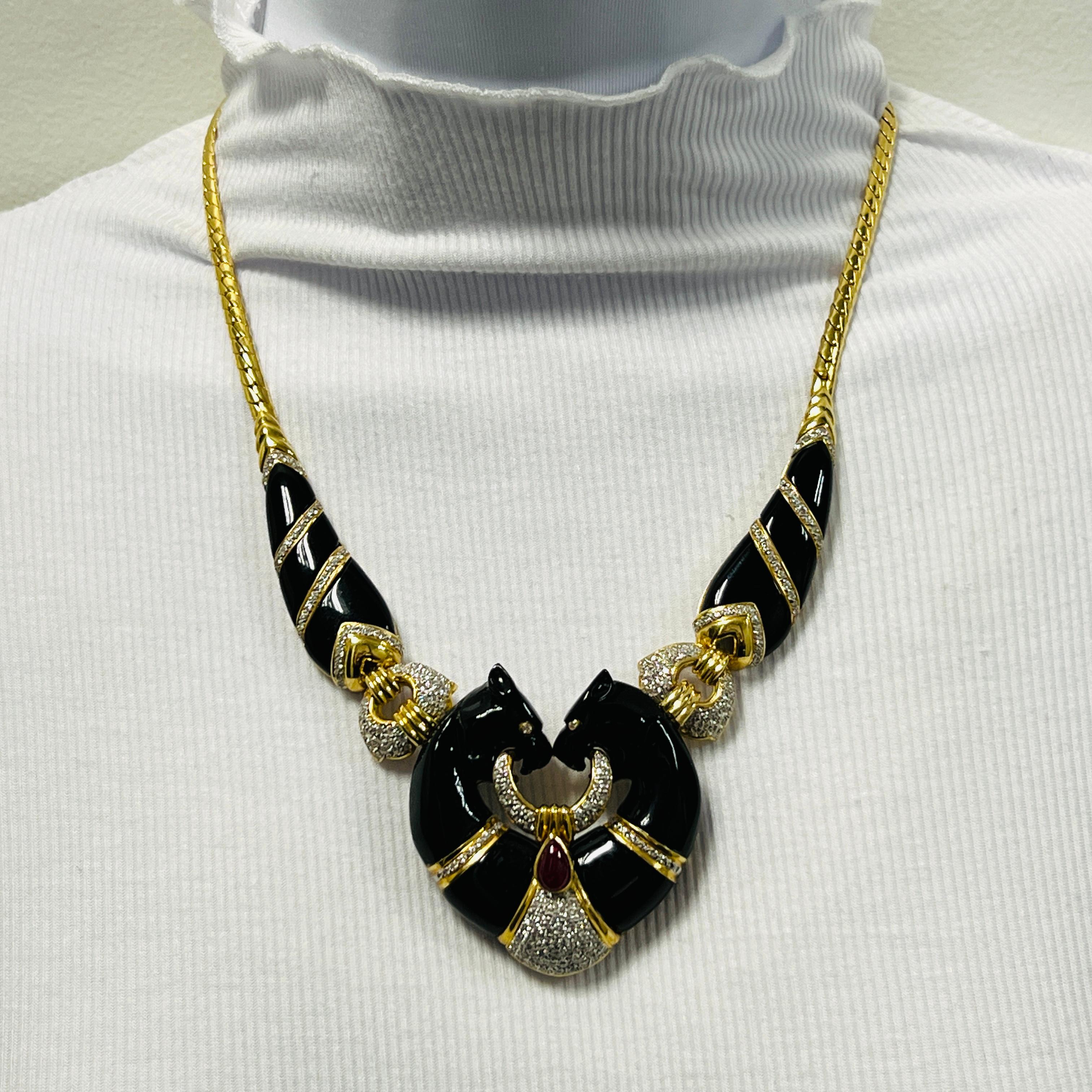 Beautiful vintage necklace featuring two panthers in black onyx, good quality white diamonds and a ruby pear shape cabochon.  Handmade in 18k yellow gold.