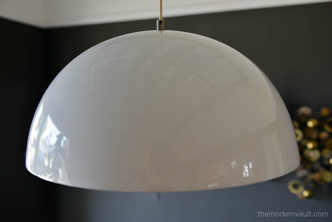 Vintage white enameled metal dome pendant Light, circa 1965. White enamel is in very good condition with only slight wear. Small indentation on one edge, barely visible as shown. Re-wired with new 6' plug in cord. Uses two 75W max bulbs.