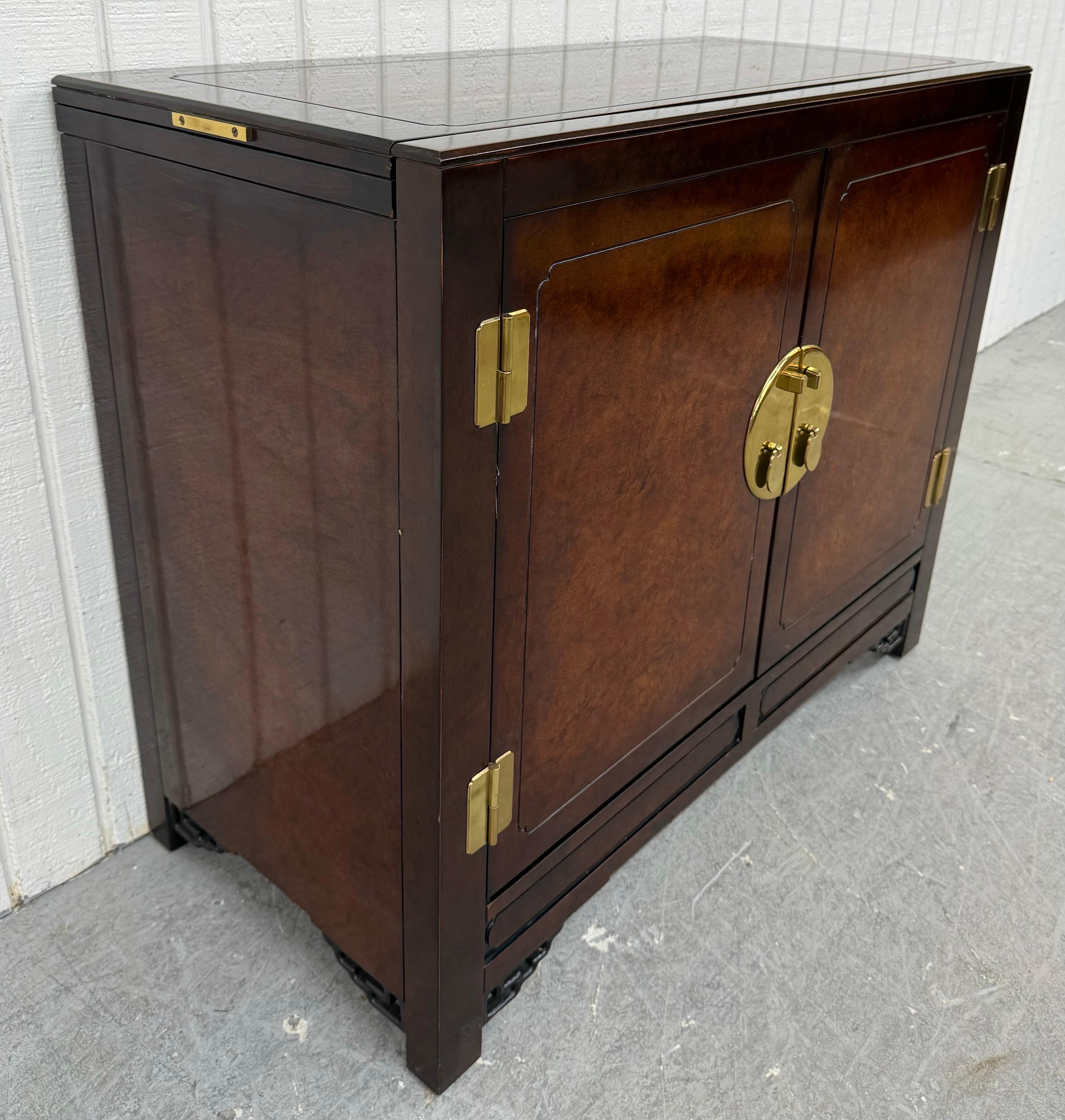 This listing is for a Vintage White Furniture Mandarin Lacquered Server. Featuring a straight line chinoiserie style design, two doors that open up to storage space, flip top that expands to 76.25” for serving space, brass hardware, and a beautiful
