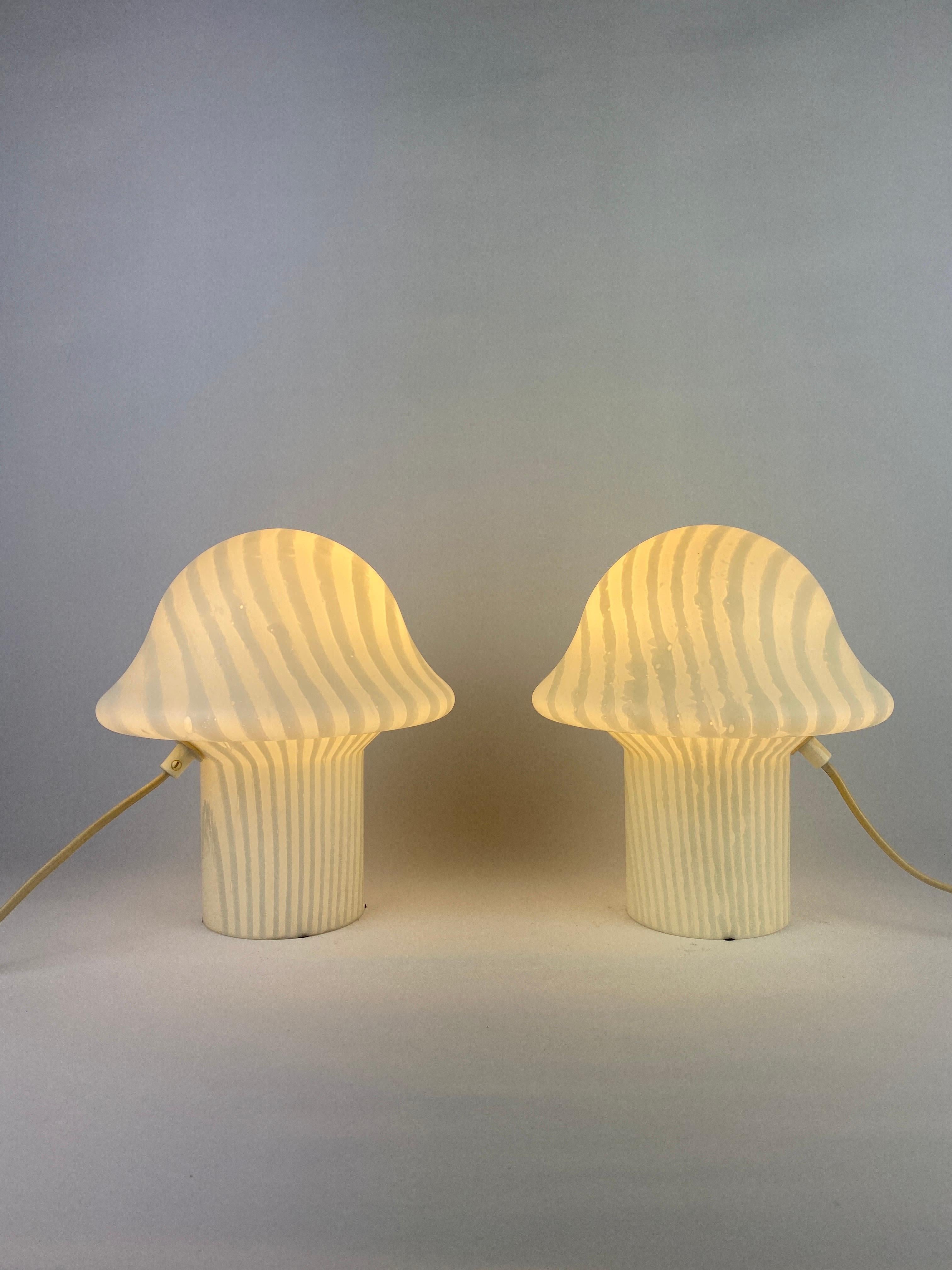 Beautiful German design by Peill and Putzler, produced around 1970 - 1980.

This lamp is made of one mouth-blown piece of crystal glass with a striped zebra print and it's shaped like a typical mid-century mushroom. The lamp is placed directly on