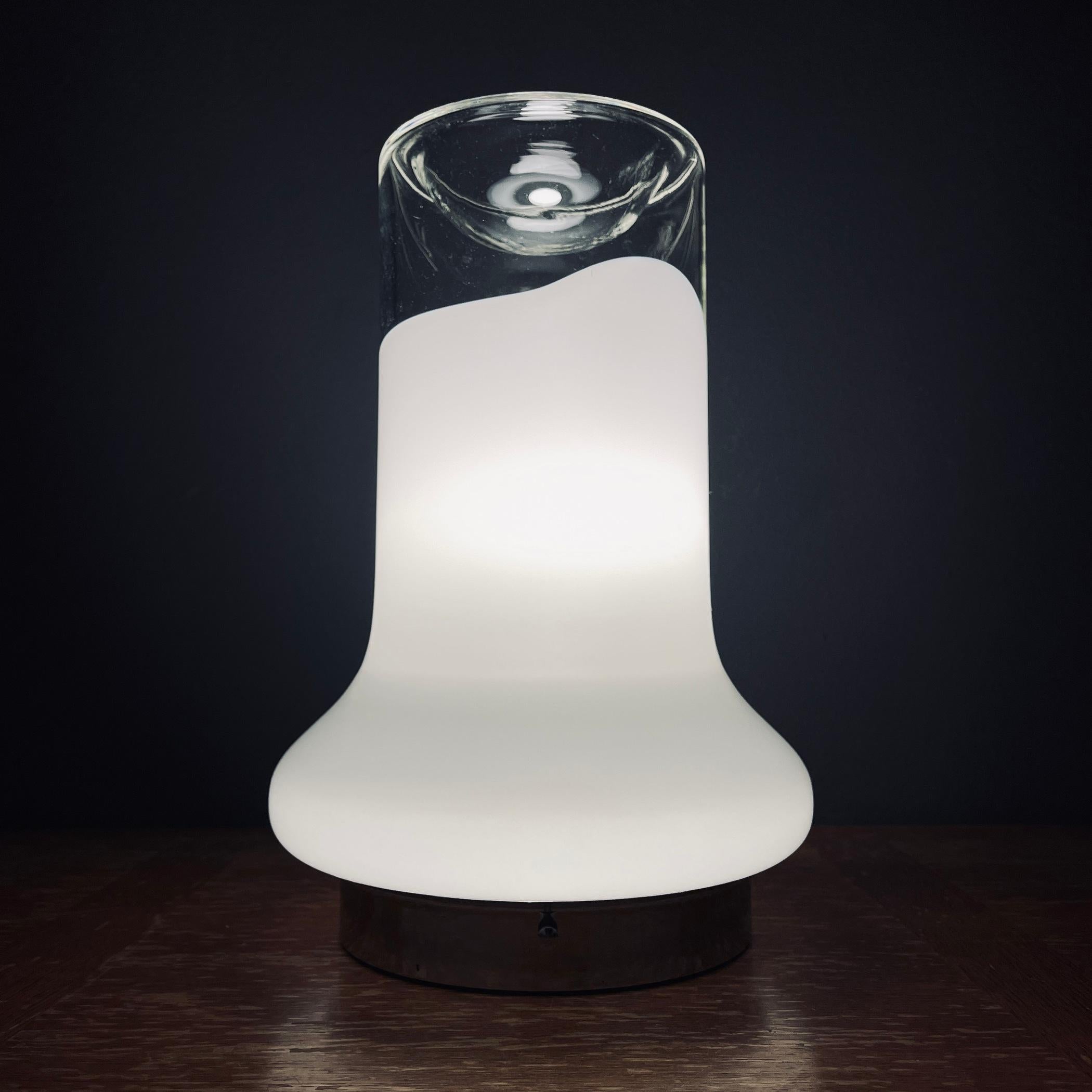 Embrace the nostalgia of 70s Italy with this vintage Murano glass table lamp designed by Roberto Pamio for Leucos. This retro lamp will transport you to the space age era, adding a touch of mid-century allure to your Art Deco or Mid-Century Modern