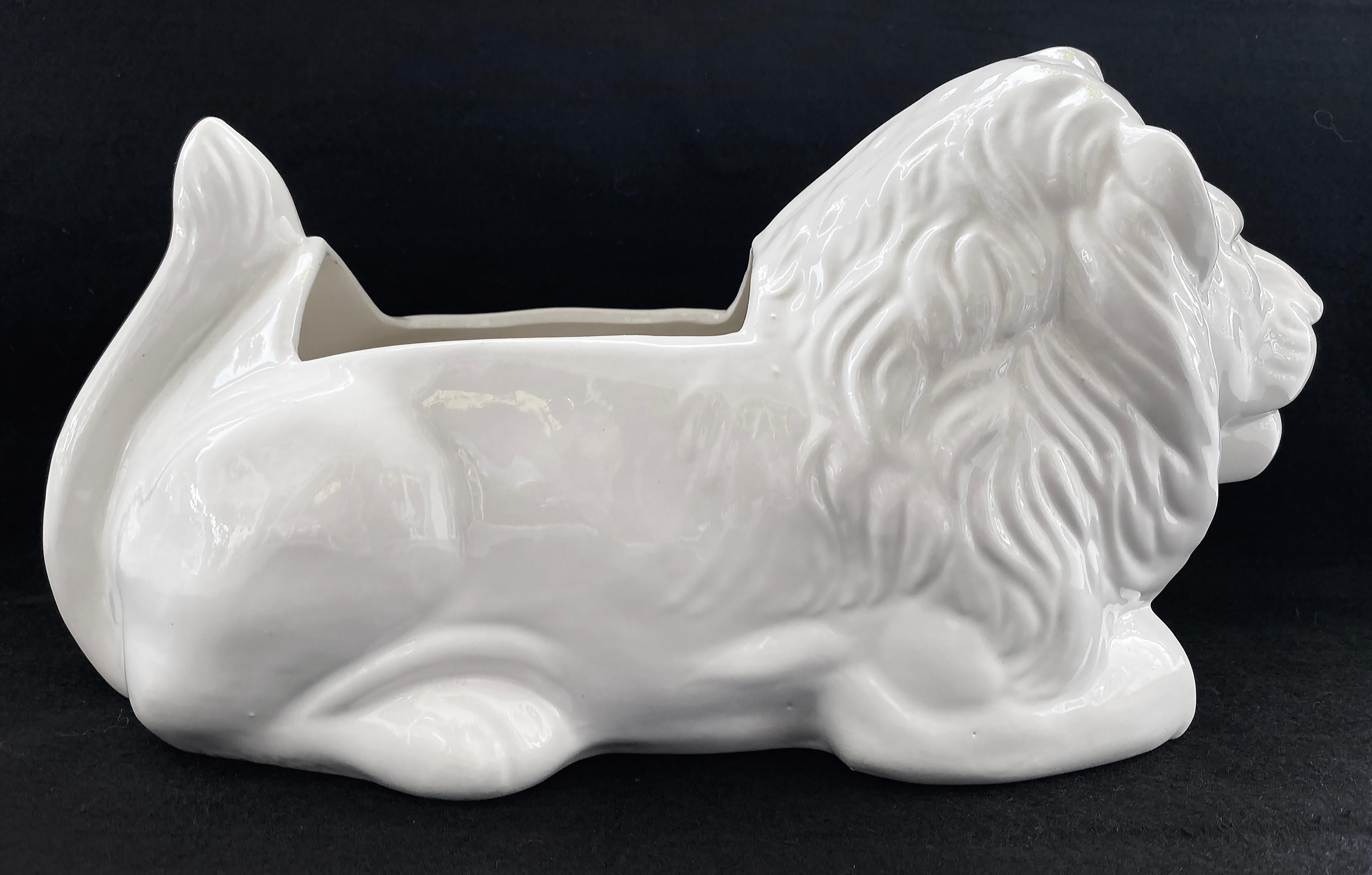 Vintage White  Glazed Ceramic Resting Lion Planter

Offered for sale is a vintage circa 1965 white glazed ceramic lion planter. The lion is positioned in a resting position and the planter is in very good condition with no issues.