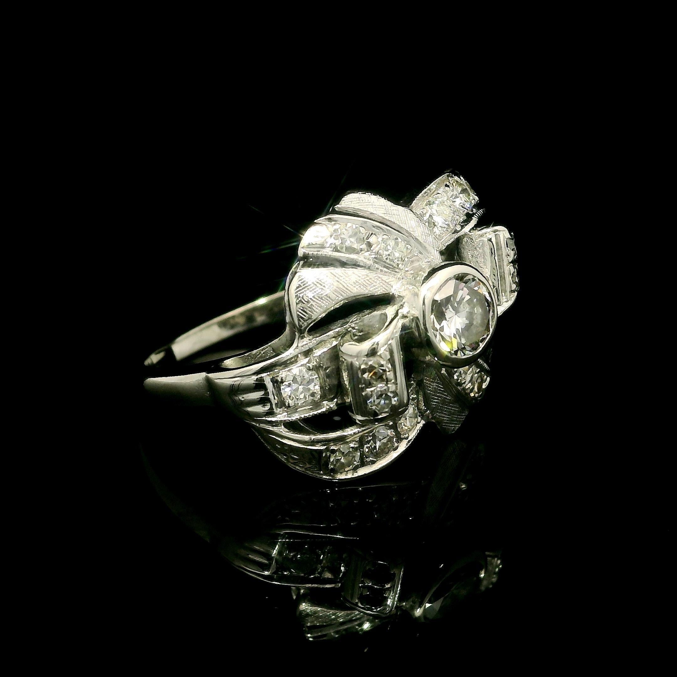 –Stone(s): –
(1) Natural White Diamond - Round Brilliant Cut - Bezel Set - H Color - VS2 Clarity - 4.56mm (approx.) - 0.45ctw (approx.)
(16) Natural White Diamond - Old Single Cut - Pave Set - White Color - 0.40ctw (approx.)

Material: 14k White