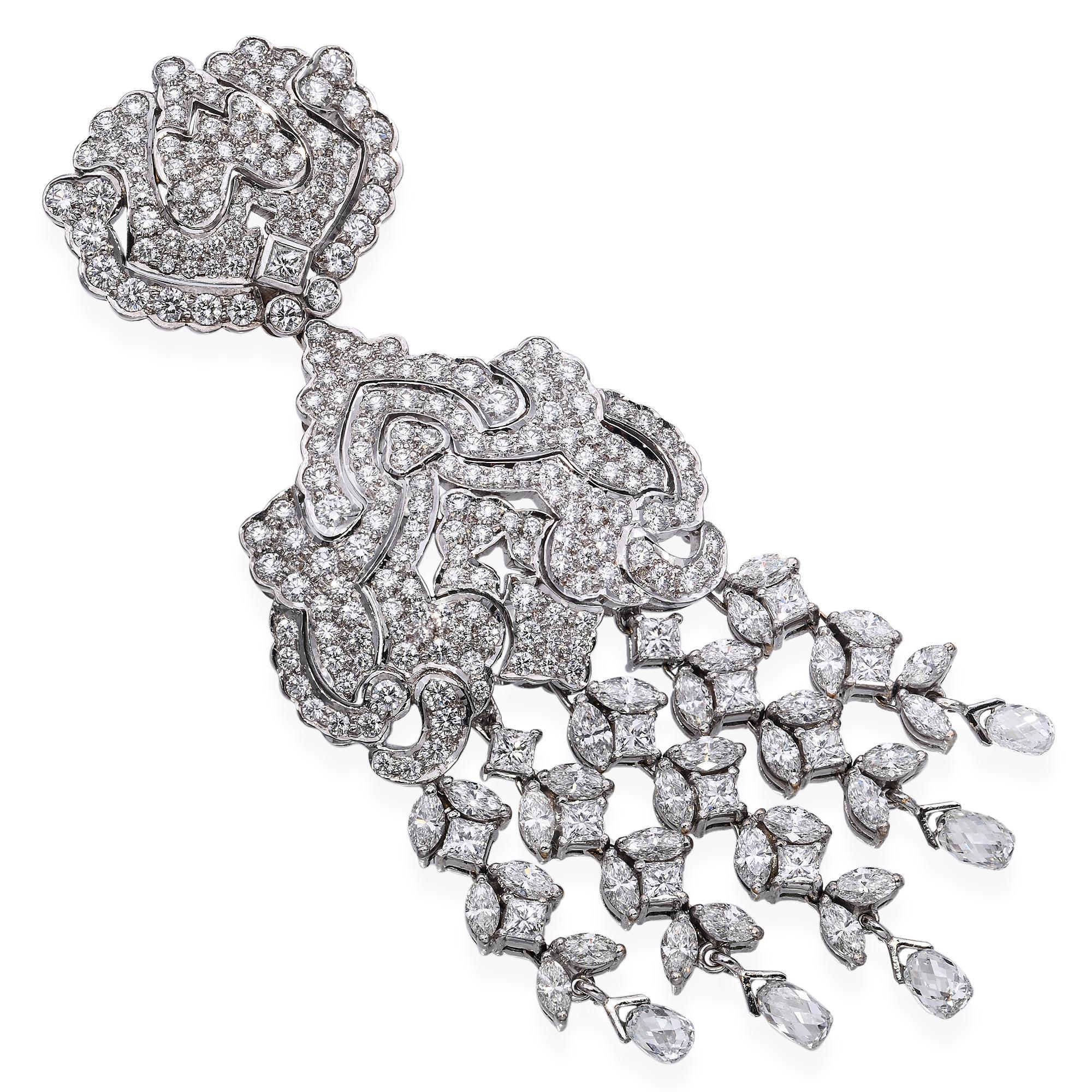 This vintage pendant is masterfully crafted in white gold and features an impressive 7.75 carats of VS1 clarity diamonds in the J–K color range. The ornate design showcases a stunning arrangement of brilliant-cut stones, accented by elegant diamond