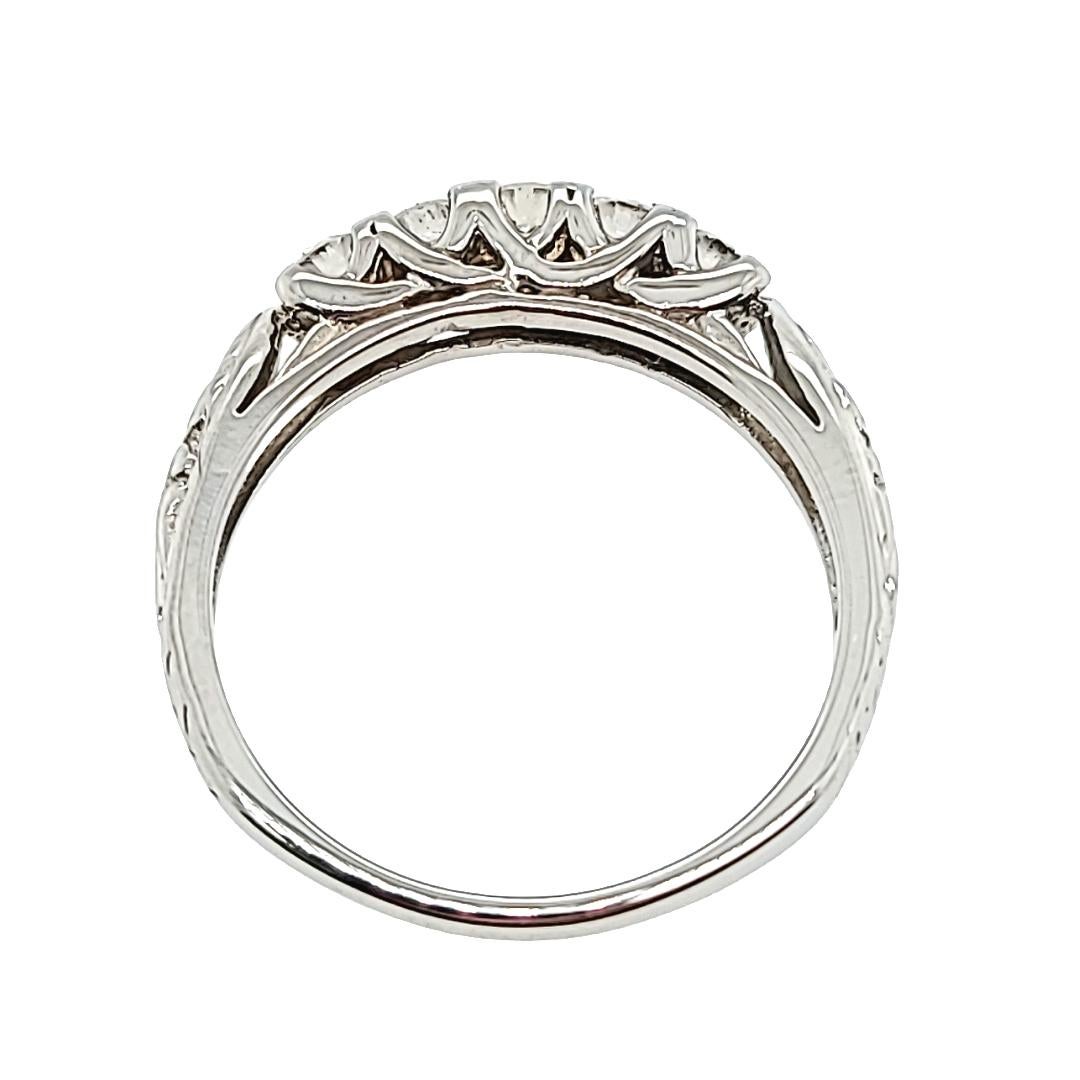 14 Karat White Gold Vintage Ring Featuring 5 Round Diamonds Of VS Clarity and G Color Totaling 0.50 Carats With Engraved Accents. Finger Size 7; Purchase Includes One Sizing Service Prior to Shipping. Finished Weight Is 3.2 Grams.