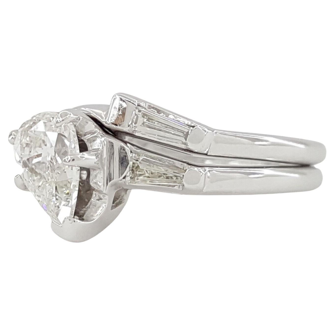 A 14k white gold engagement ring and wedding band set features a pear-cut diamond as the centerpiece. The rings, weighing a total of 3.8 grams and sized at 3 (with the ability to be resized to a larger size), showcase a natural pear brilliant-cut