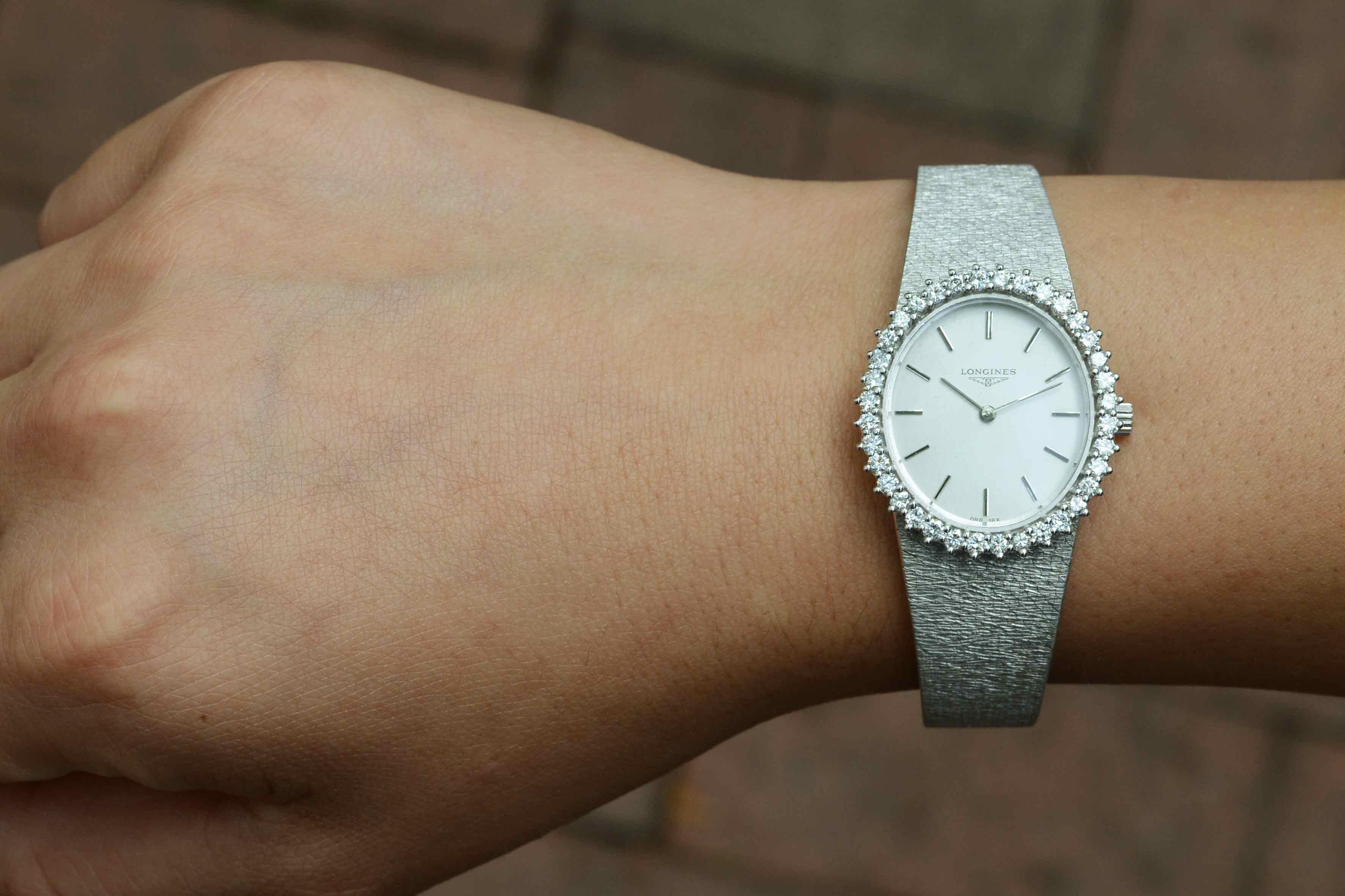 An unusual vintage ladies' Longines cocktail dress watch. The 18K white gold bracelet and oval dial adorned with 36 dazzling diamonds totaling 1 carat. A very pretty and infinitely fashionable addition to your collection of jewelry and
