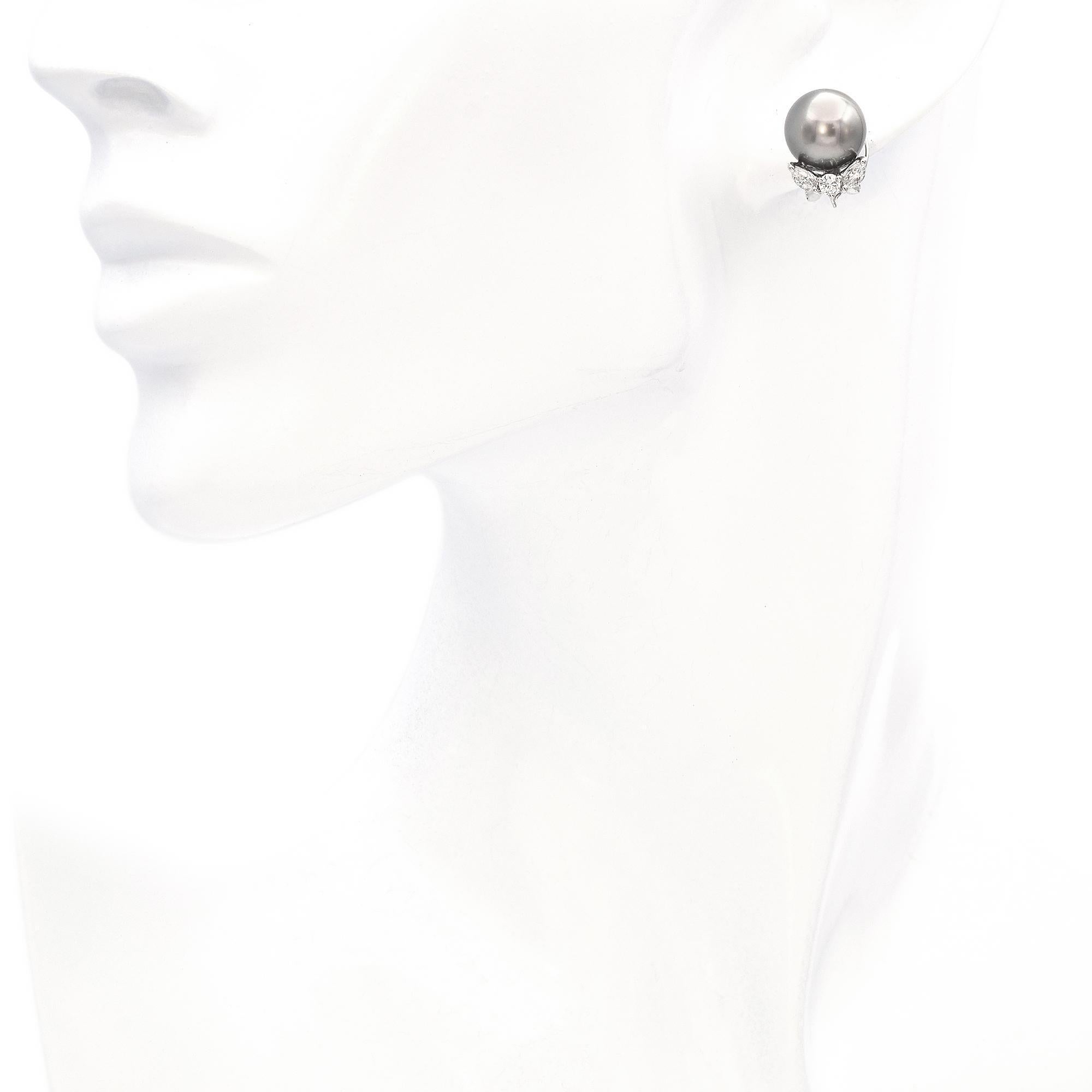 A sophisticated pair of stud earrings, each crafted in white gold, featuring lustrous pearls. Accented with 0.64 carats of round brilliant-cut diamonds.

Weight: 6.9 Grams
Stone: Pearl (10.25 mm) and 0. 64 TCW HI-SI Diamonds ( 2.75mm Round, 4.25 x
