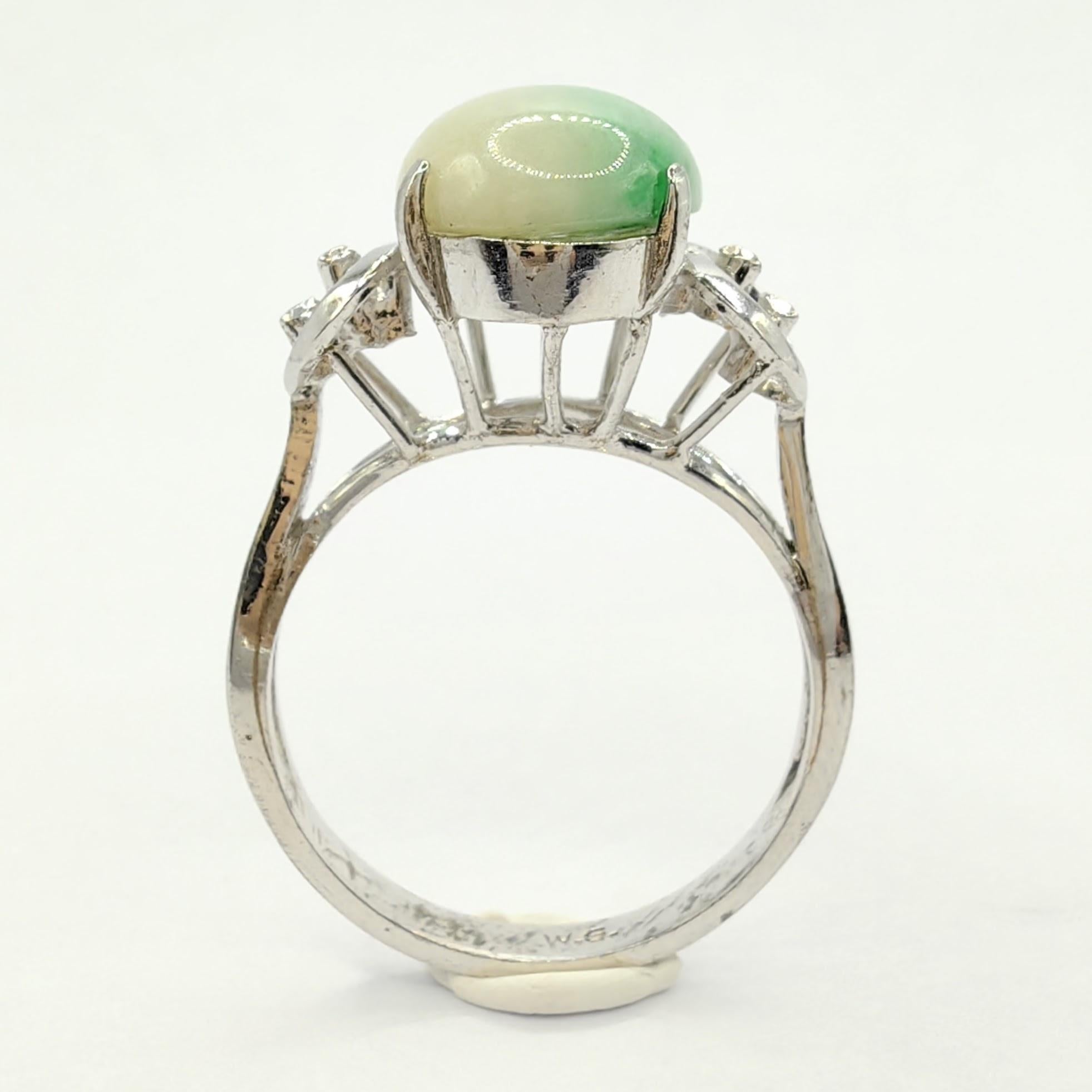 Introducing our exquisite Vintage Solitaire White & Green Jade Ring in White Gold, a captivating piece that seamlessly combines the elegance of white gold with the allure of a stunning cabochon cut jade gemstone. This unique ring showcases a