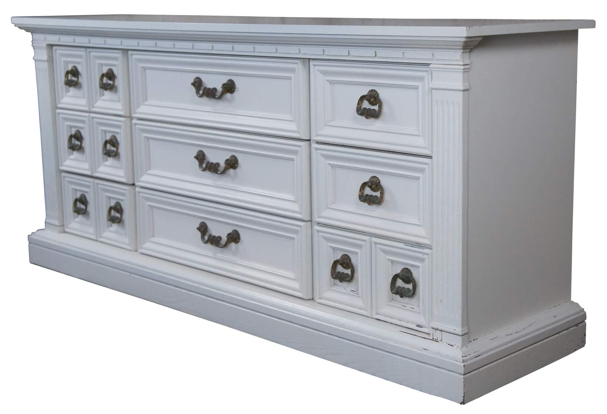 Italian Mediterranean style painted dresser, circa 1980s. A rectangular form made from oak with 9 drawers drawers. Features corinthian style columns along the outside and ornate hardware. Attributed to Drexel. Size: 70