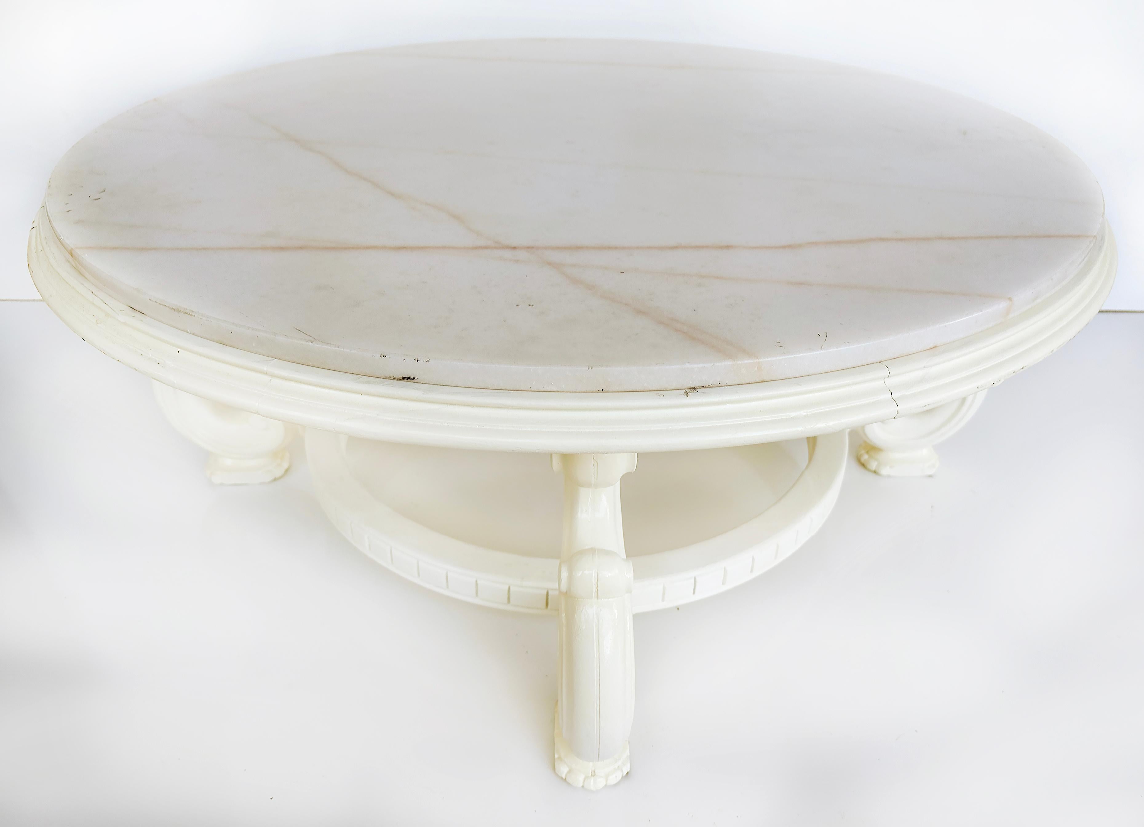 Vintage White Lacquered Round Marble Top Coffee Table

Offered for sale is s a vintage white lacquered marble top coffee table. The table has previously been finished in white. The table is supported by four scrolled legs that return to a round