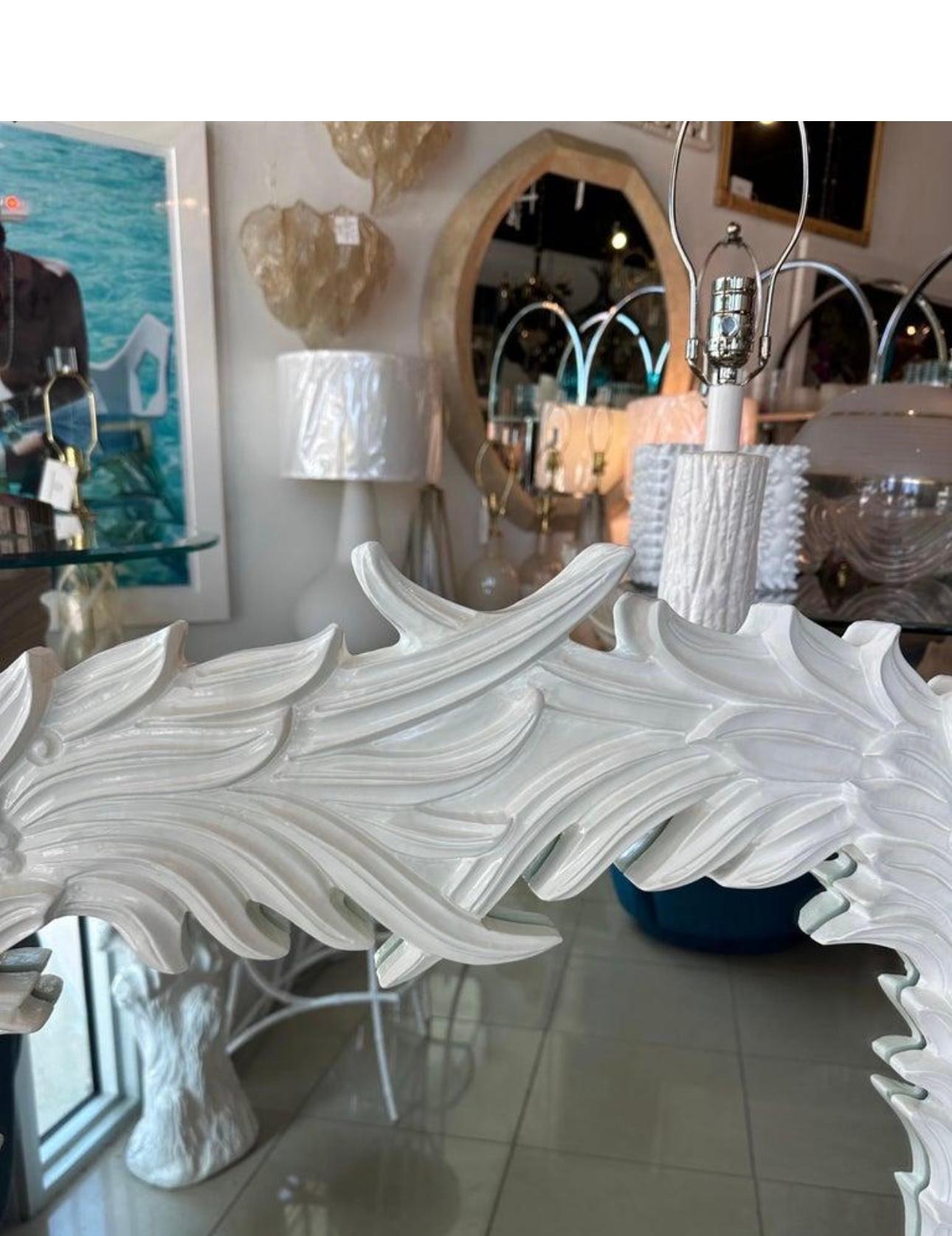 Beautiful vintage Palm Beach tropical palm frond leaf tree leaves wall mirror in the style of Serge Roche. Newly lacquered in a soft satin white. Comes ready to hang. Dimensions: 49 H x 31.5 W x 1.75 D.
