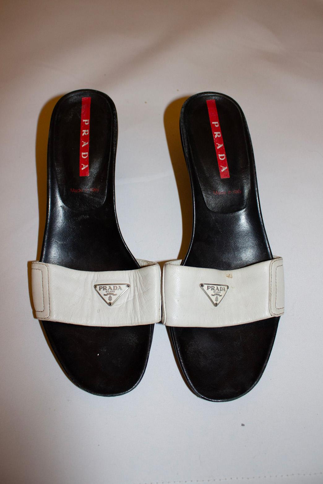 A chic pair of vintage mules by Prada. The tops are white leather with the Prada logo.
Size 38 Made in Italy, heel height  2 1/2''