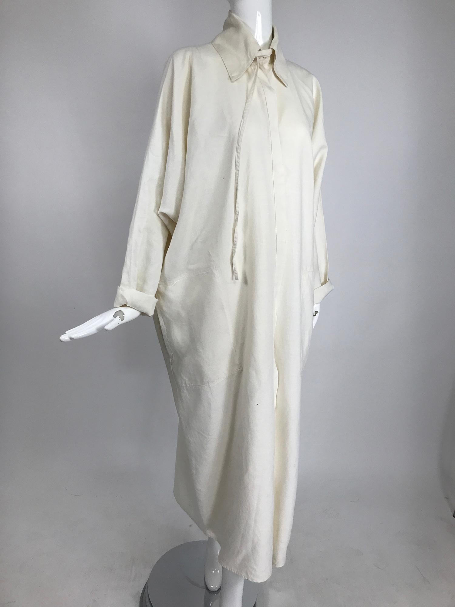 Vintage white (ivory) linen duster, coat, it's oversized as was the style in the 1990s. Beautiful quality linen coat with a very unique closure at the neck see photo. Wing collar coat has bat wing sleeves and turn back cuffs. The coat is open at the