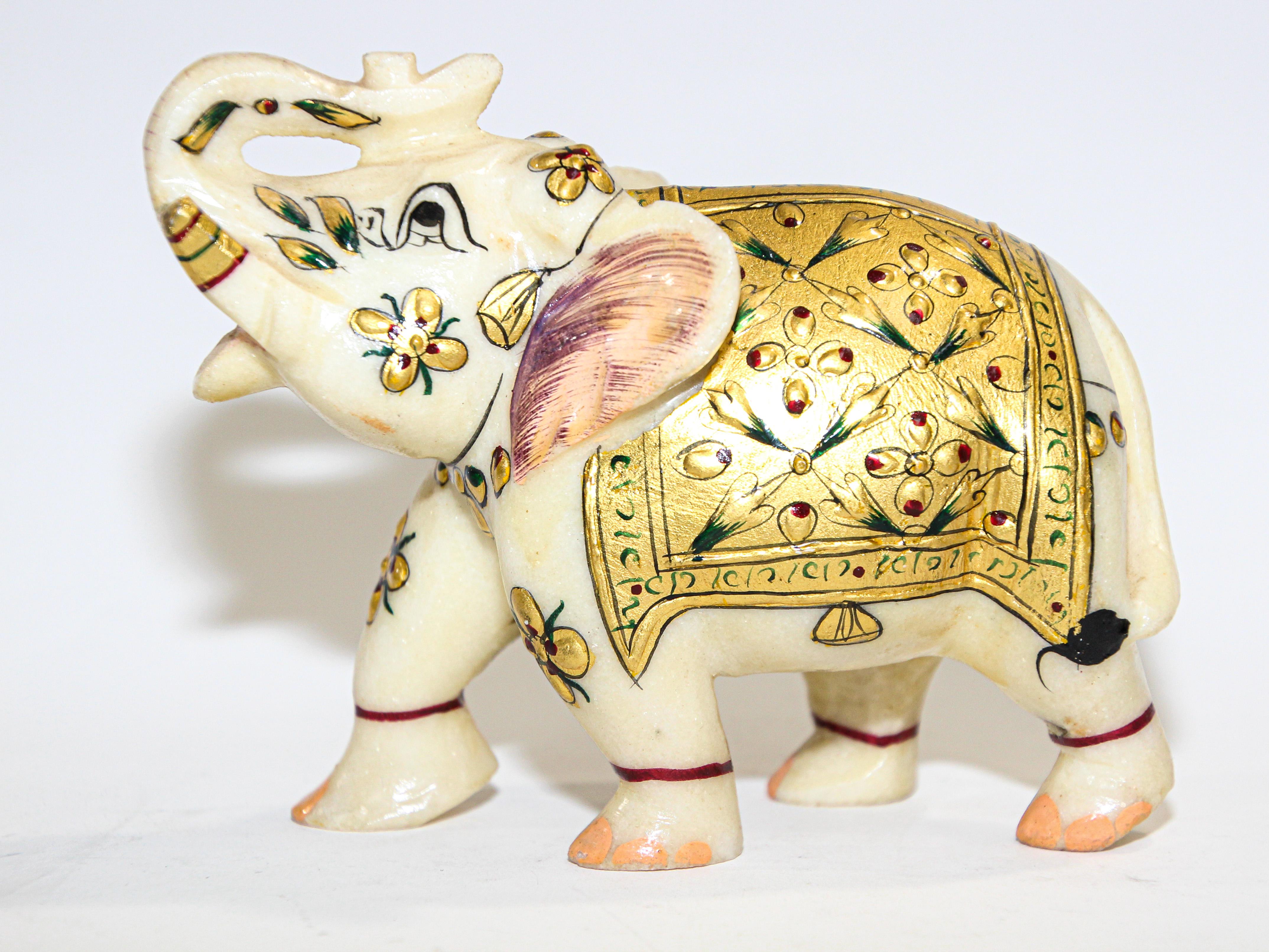 Vintage jeweled elephant sculpture paper weight wearing traditional ceremonial costume.
Finely hand painted animal sculpture of an elephant with colorful gold, green and red color paint.
Collectible ceremonial hand carved white marble stone