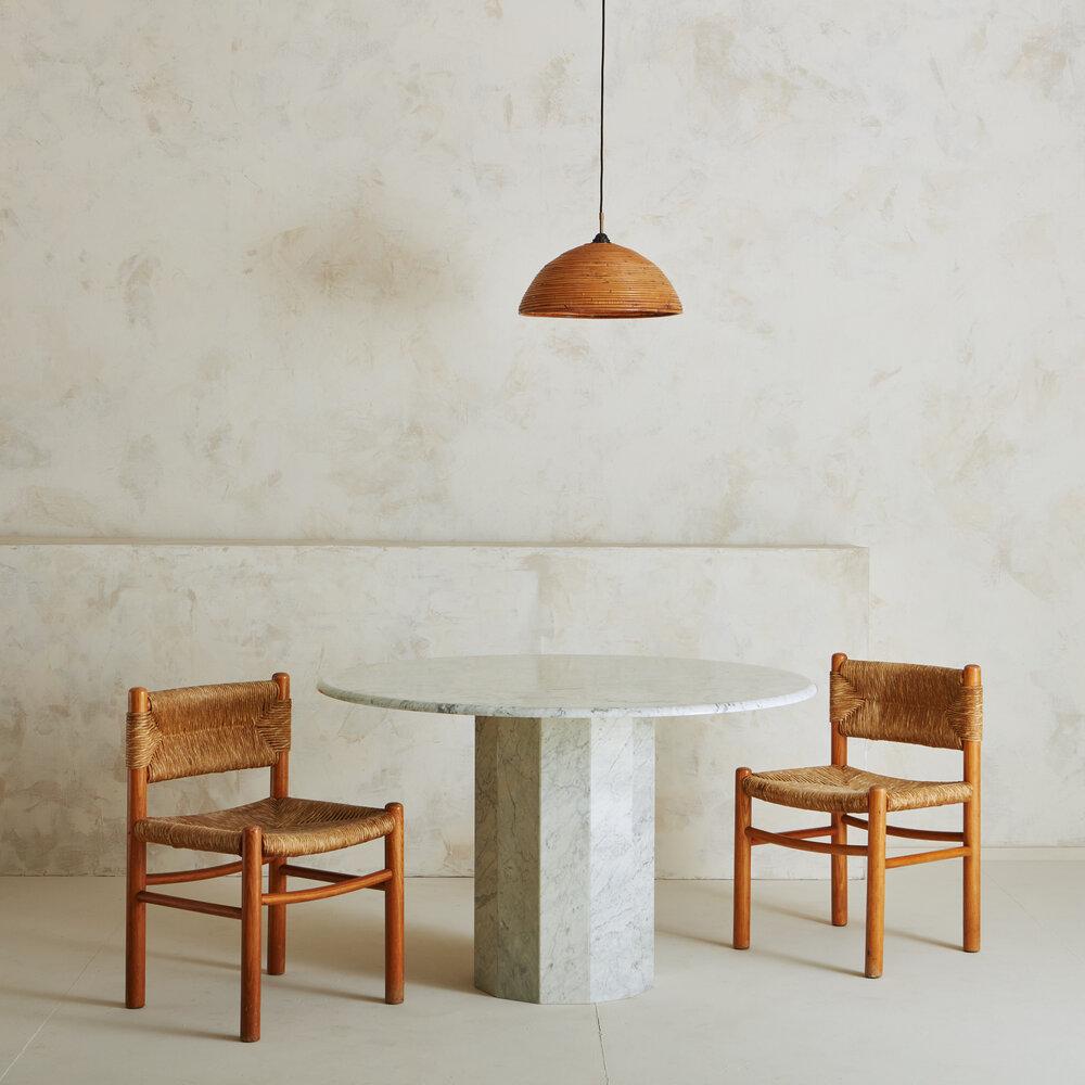 A stunning marble dining or entryway table with a round 1” thick top resting on a faceted, mitered decagon pedestal base. This marble is a refined shade of white with subtle gray veining. 

Pedestal Base 28.5”High x 17”Diameter; Top 47”Diameter x