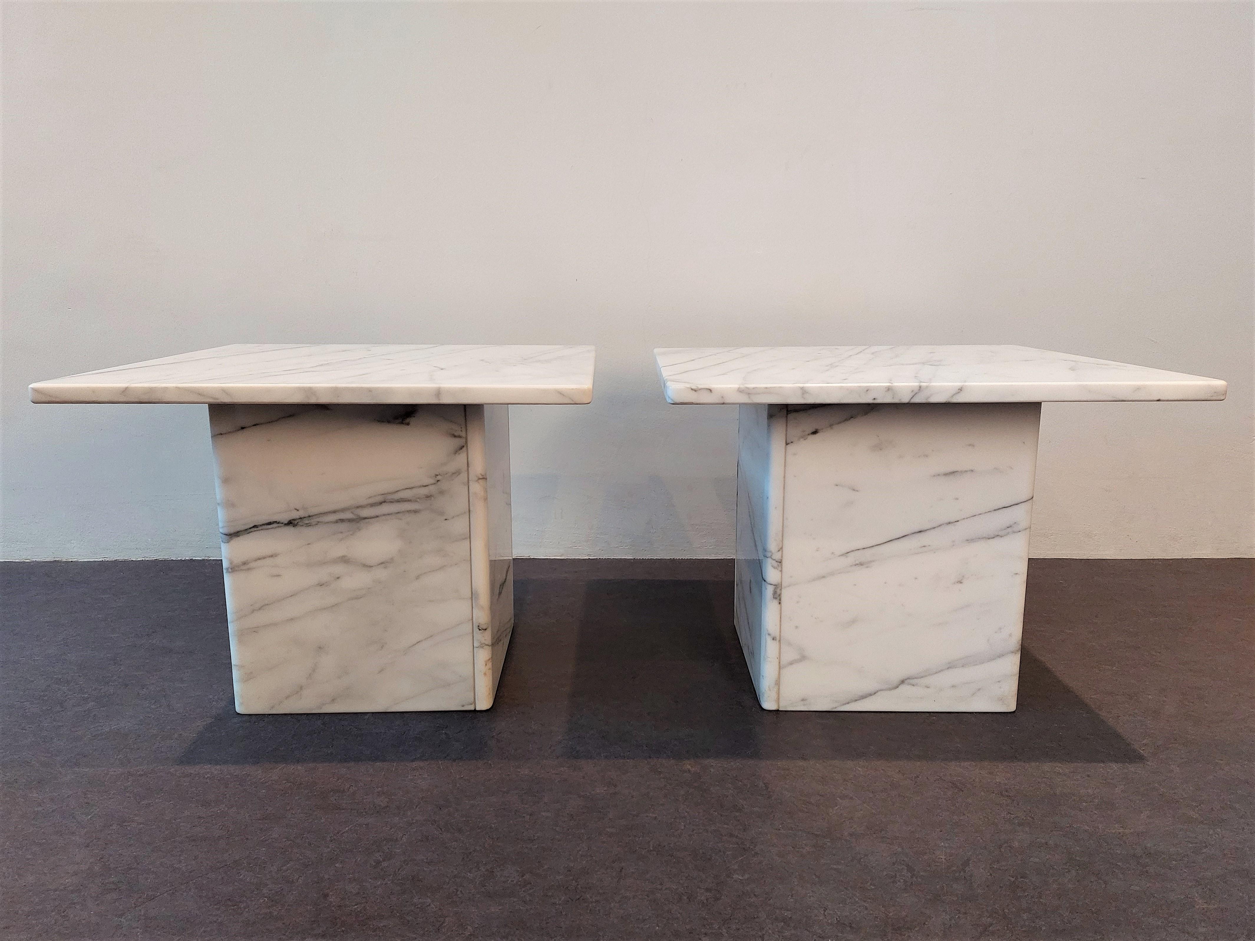 We have two of these side tables available. A square white marble top on a white marble base. All is in a good to very good condition with minor signs of age and use. The base consists out of 4 slats of marble glued together in a square with rounded