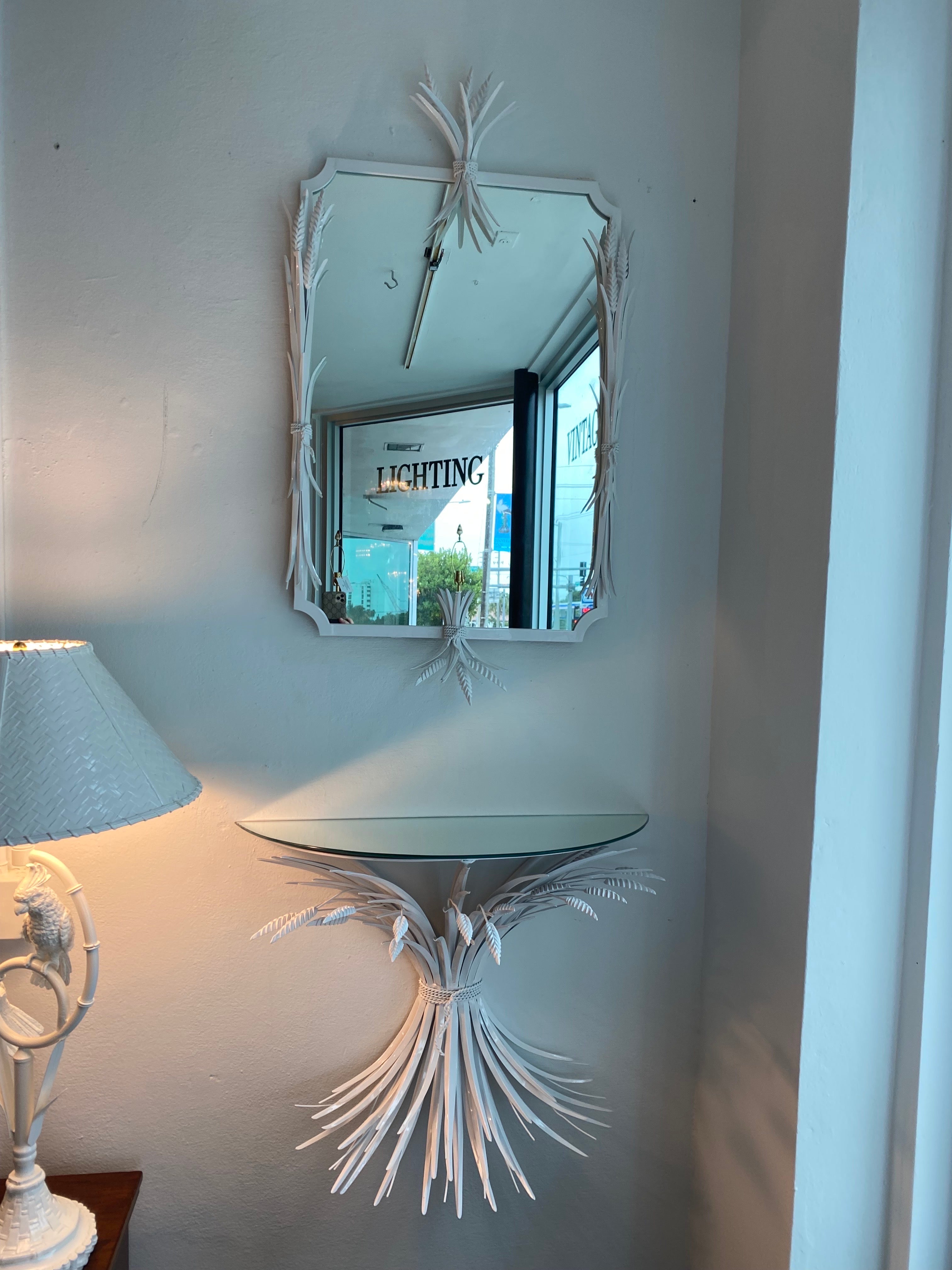 Vintage 1950's metal tole wall mirror and Demi lune wall console with mirror top. Newly powder-coated in a fresh white. New mirror top. Mounts to wall. New mirror inside frame. Mirror Dimensions: 42 H x 32 W x 3 D. Console Table Dimensions: 24 H x