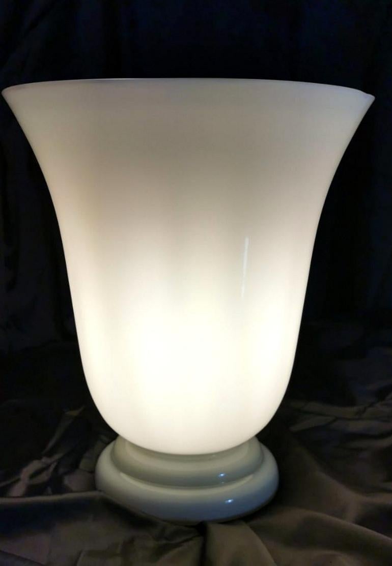 Elegant French lamp in opaline glass with a milky white color, the base, also in opal glass, has a denser texture and the color fades on the blue; the design is linear and essential, typical of the 1950s when it is on, the lamp assumes an even more