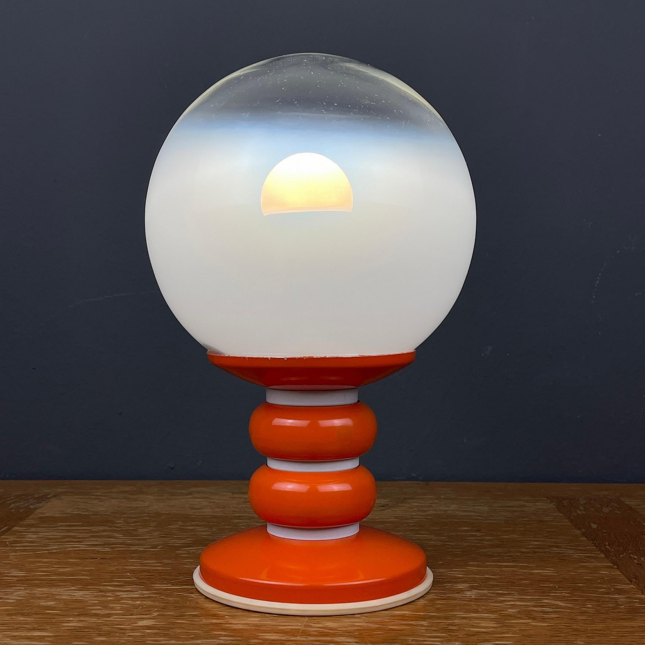 Revamp your space with this stunning vintage white table lamp, lovingly crafted in Italy during the iconic 1970s era. Immerse yourself in the atmosphere of Space Age Italy as you bring home this retro lamp, a true testament to the stylish design of