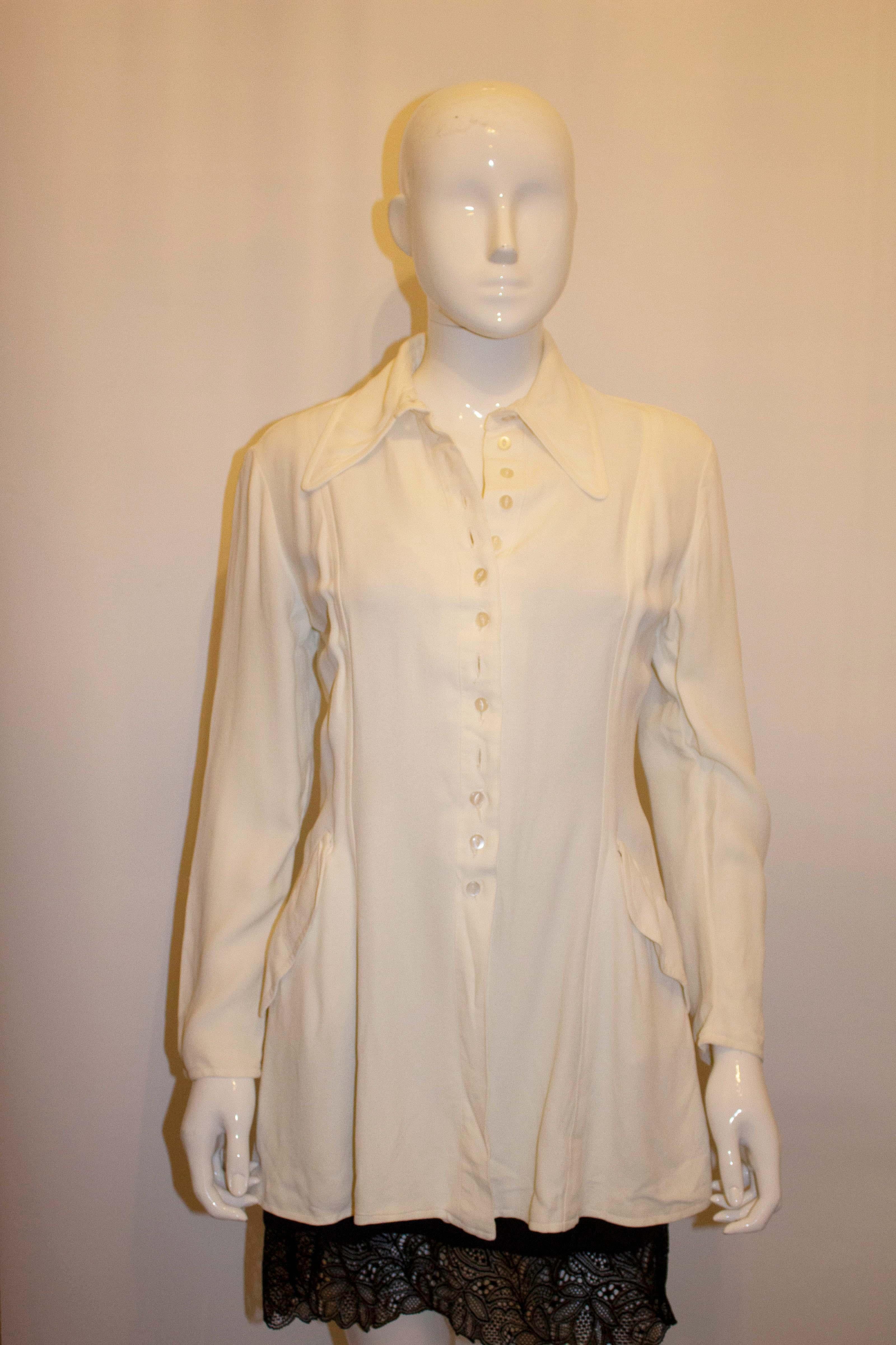 A fun white vintage mosss crepe jacket by Ossie Clark for Radley.  The jacket has a pointed collar with two pockets  and a button front opening. 
Measurements: Bust up to 38'', length 29''