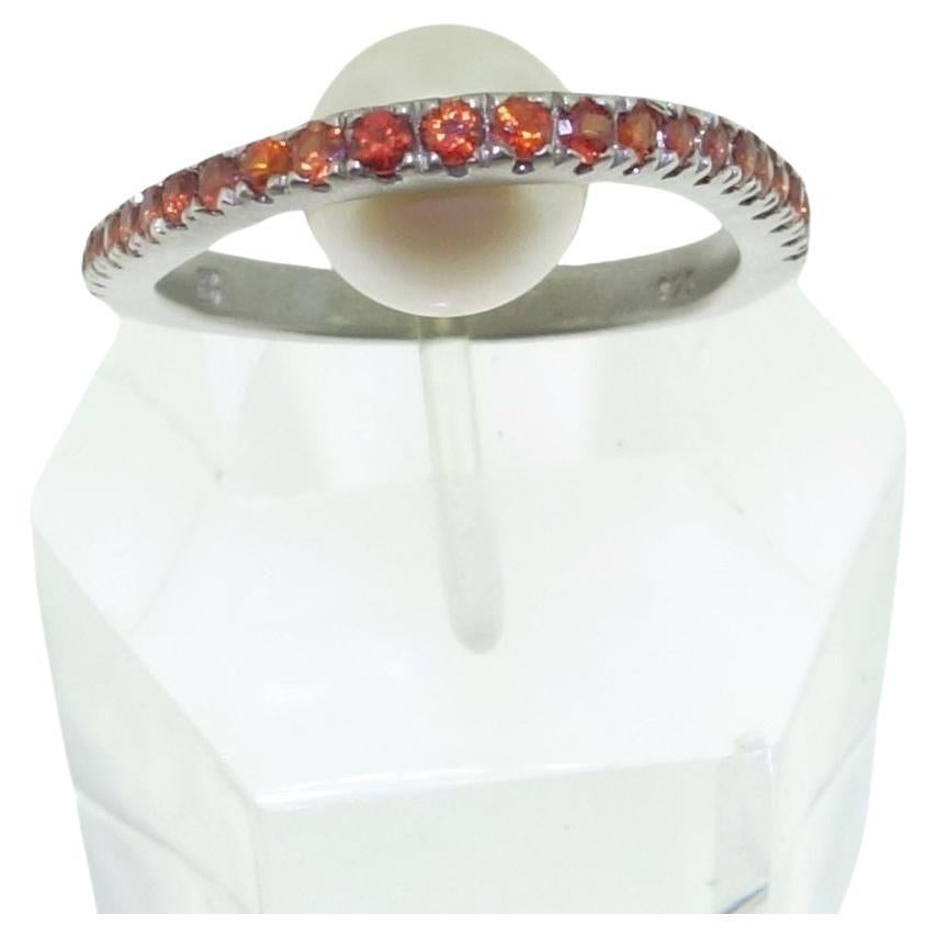 Simply Beautiful! With an 8.80mm White freshwater Pearl below with top of Ring Hand set with 23 Diamond-Cut 1.9mm Round Natural Orange Sapphires; weighing approx.  0.70tctw. 925 Sterling Silver Tarnish-resistant Rhodium mounting and 14K White Gold.